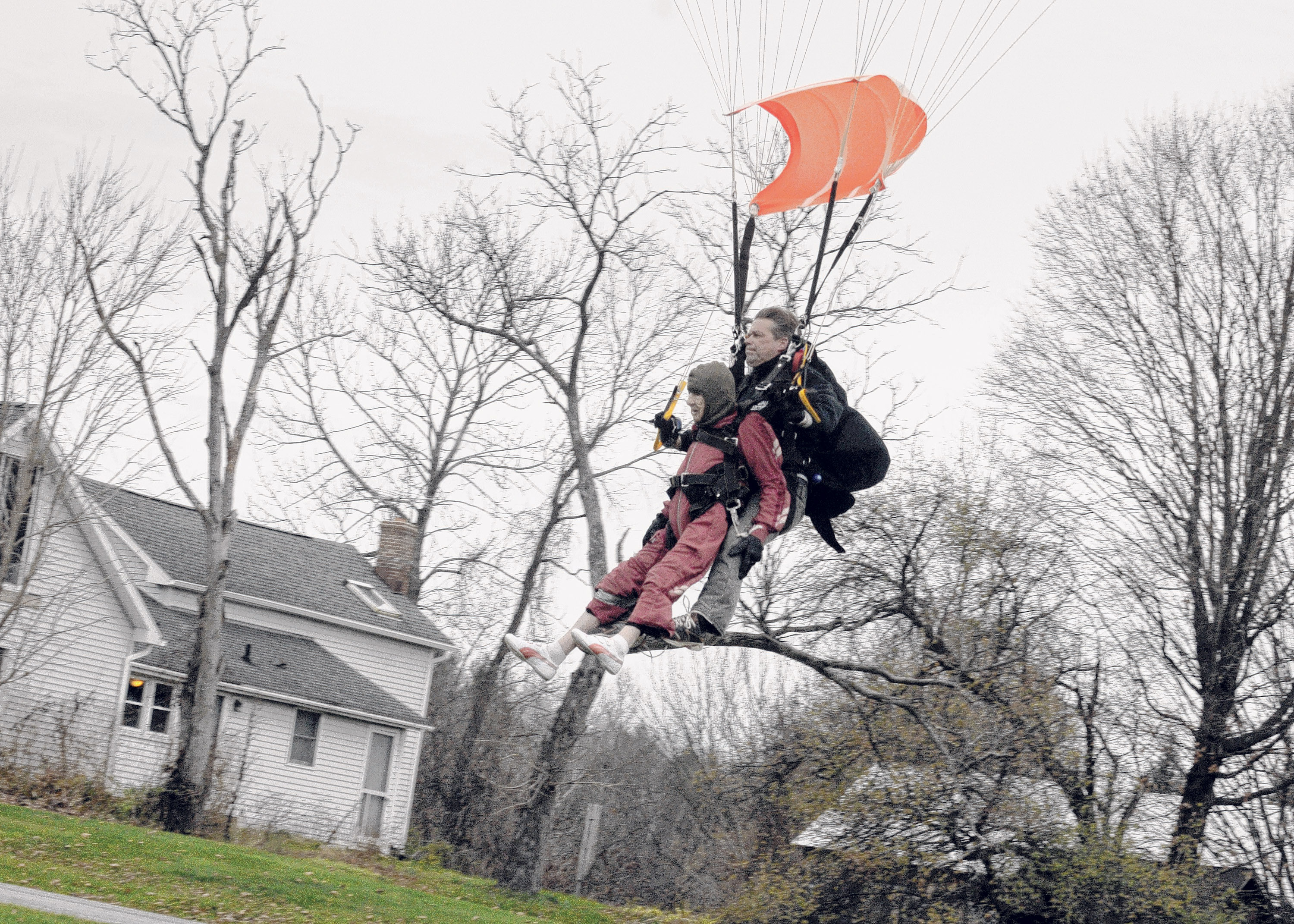 In this Saturday, Nov. 8, 2014 photo, Eleanor "Nanny" Cunningham, left, with tandem master Dean McDonald, come in for a landing after their skydive in Gansevoort, N.Y, a day after her 100th birthday. It was Cunningham's third jump, after taking up the sport at age 90. (AP Photo/The Albany Times Union, Michael P. Farrell)  TROY, SCHENECTADY; SARATOGA SPRINGS; ALBANY OUT (AP)