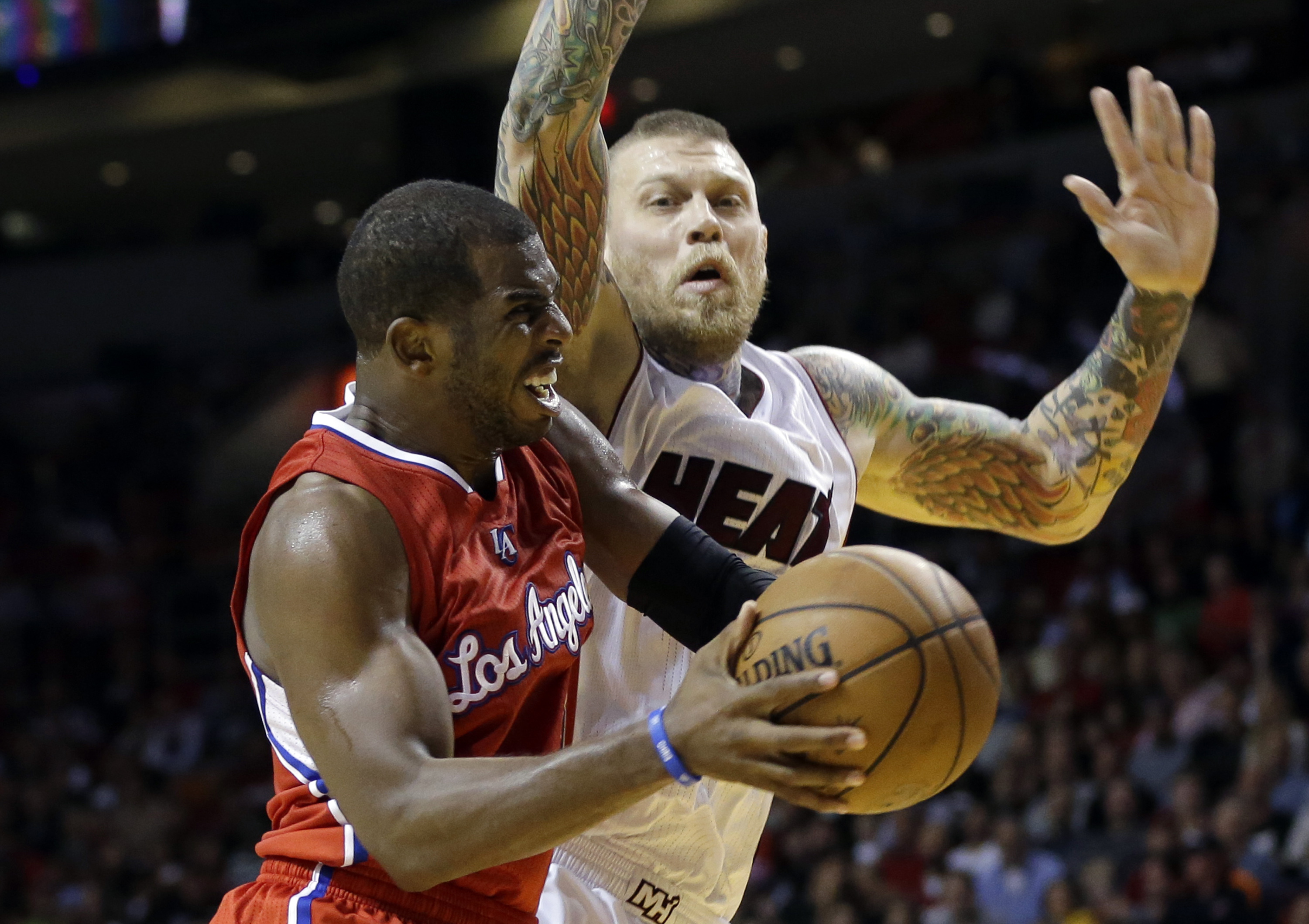 Los Angeles Clippers guard Chris Paul, left, goes up to shoot as Miami Heat forward Chris Andersen, right, defends in the second half of an NBA basketball game, Thursday, Nov. 20, 2014, in Miami. The Clippers defeated the Heat 110-93. (AP Photo/Lynne Sladky) (AP)