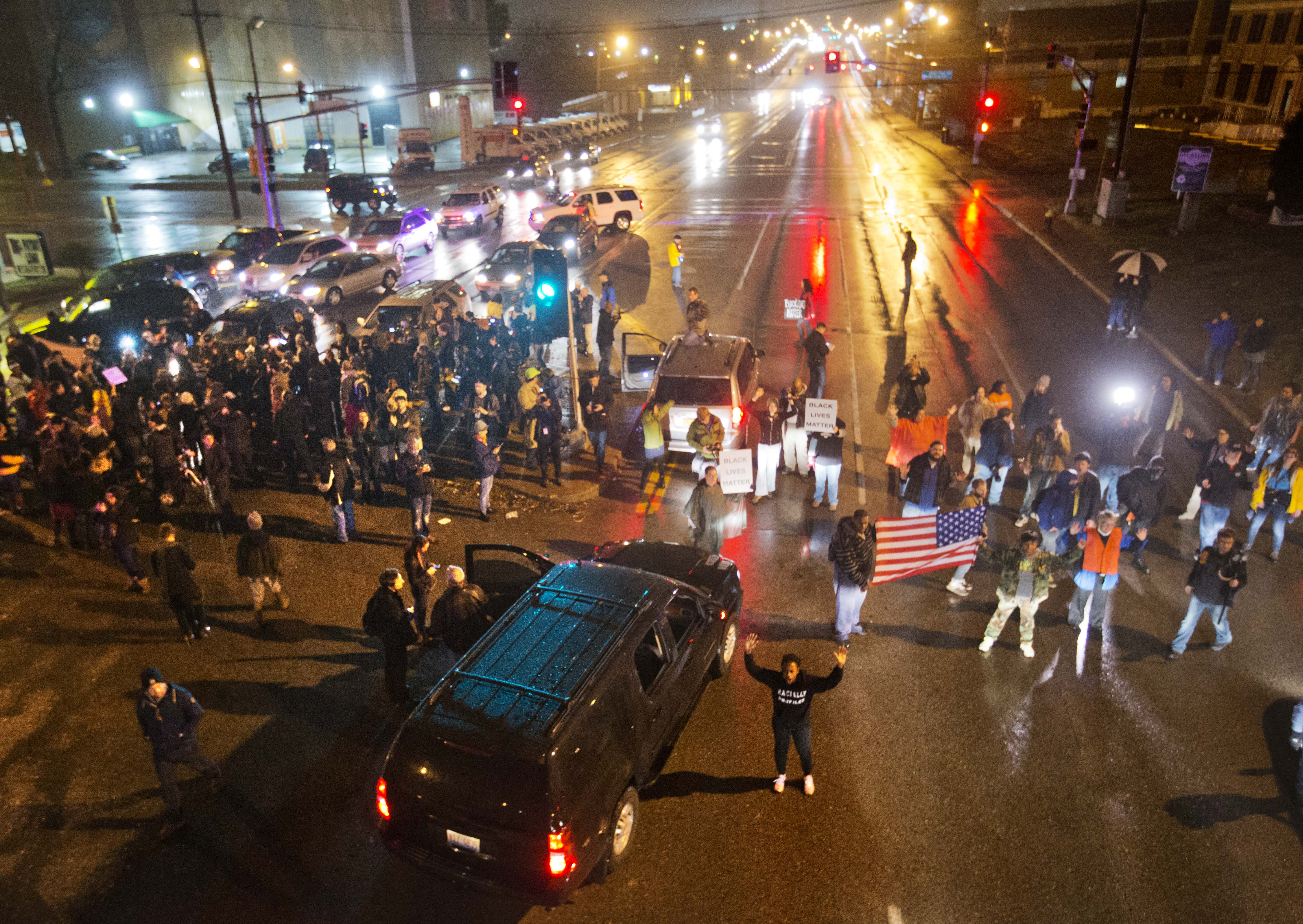 Demonstrators block a busy intersection while marching through the streets to protest the August shooting of Michael Brown, Sunday, Nov. 23, 2014, in St. Louis. Ferguson and the St. Louis region are on edge in anticipation of the announcement by a grand jury whether to criminally charge officer Darren Wilson in the killing of 18-year-old Brown. (AP Photo/David Goldman) (AP)