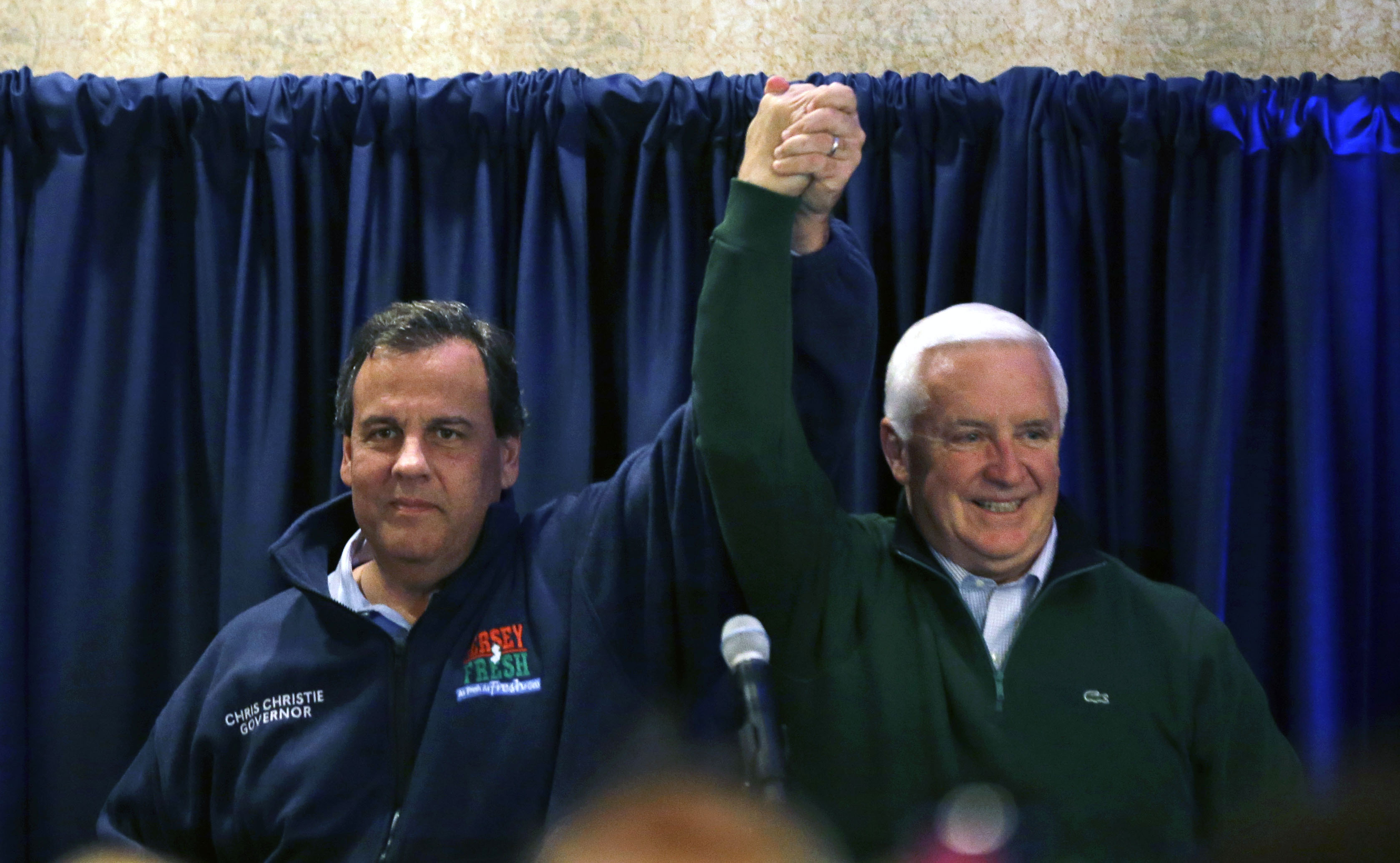Pennsylvania Gov. Tom Corbett, right, and New Jersey Gov. Chris Christie raises the arms at a gathering at a campaign rally Sunday, Nov. 2, 2014, in Ivyland, Pa. Corbett will face Democratic challenger Tom Wolf in Tuesday's election. (AP Photo/Mel Evans) (AP)