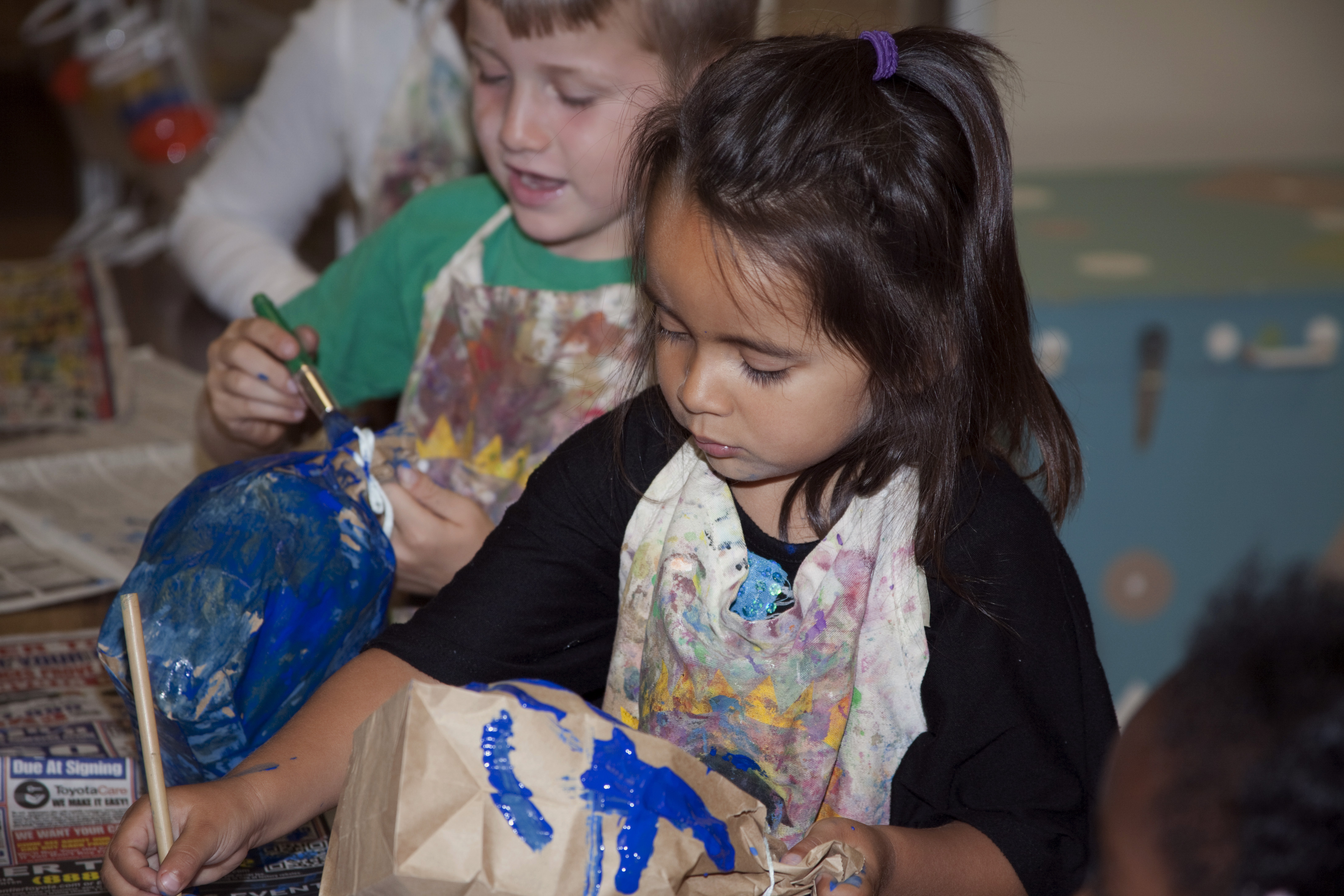 In this June 2014 photo provided by Transition House, a homeless shelter in Santa Barbara, Calif., Melody, 4, makes a paper whale after listening to a story about whales during the Transition Houses Technology and Literacy for Children story time. A new report released Monday, Nov. 17, 2014, by the National Center on Family Homelessness says that one fifth of America's homeless children are in California. (AP Photo/Transition House, Kimberly Kavish) (AP)