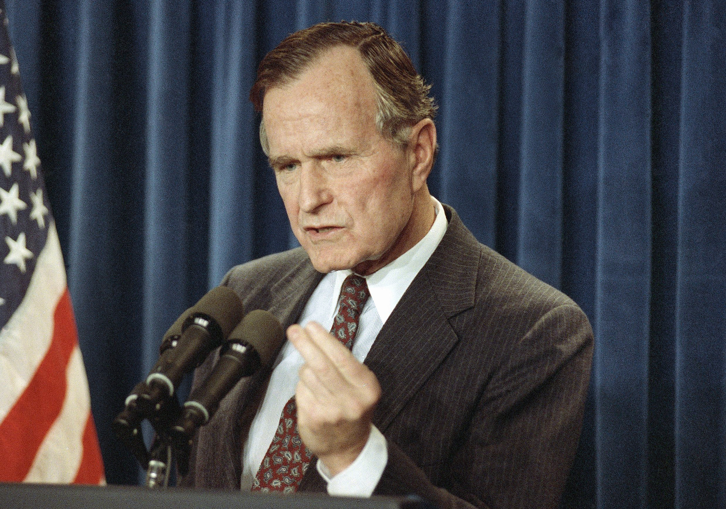 FILE - In this Jan. 12, 1991 file photo, President George H.W. Bush speaks during a news conference at the White House in Washington. President Barack Obama's impending unilateral order awarding legal status to millions of immigrants is not unprecedented. Two of the last three Republican presidents _ Ronald Reagan and George H.W. Bush _ did the same thing in extending amnesty to family members not covered by the last major overhaul of  immigration law in 1986. There was no political explosion then comparable to the one Republicans are threatening now.  (AP Photo/Charles Tasnadi, File) (AP)