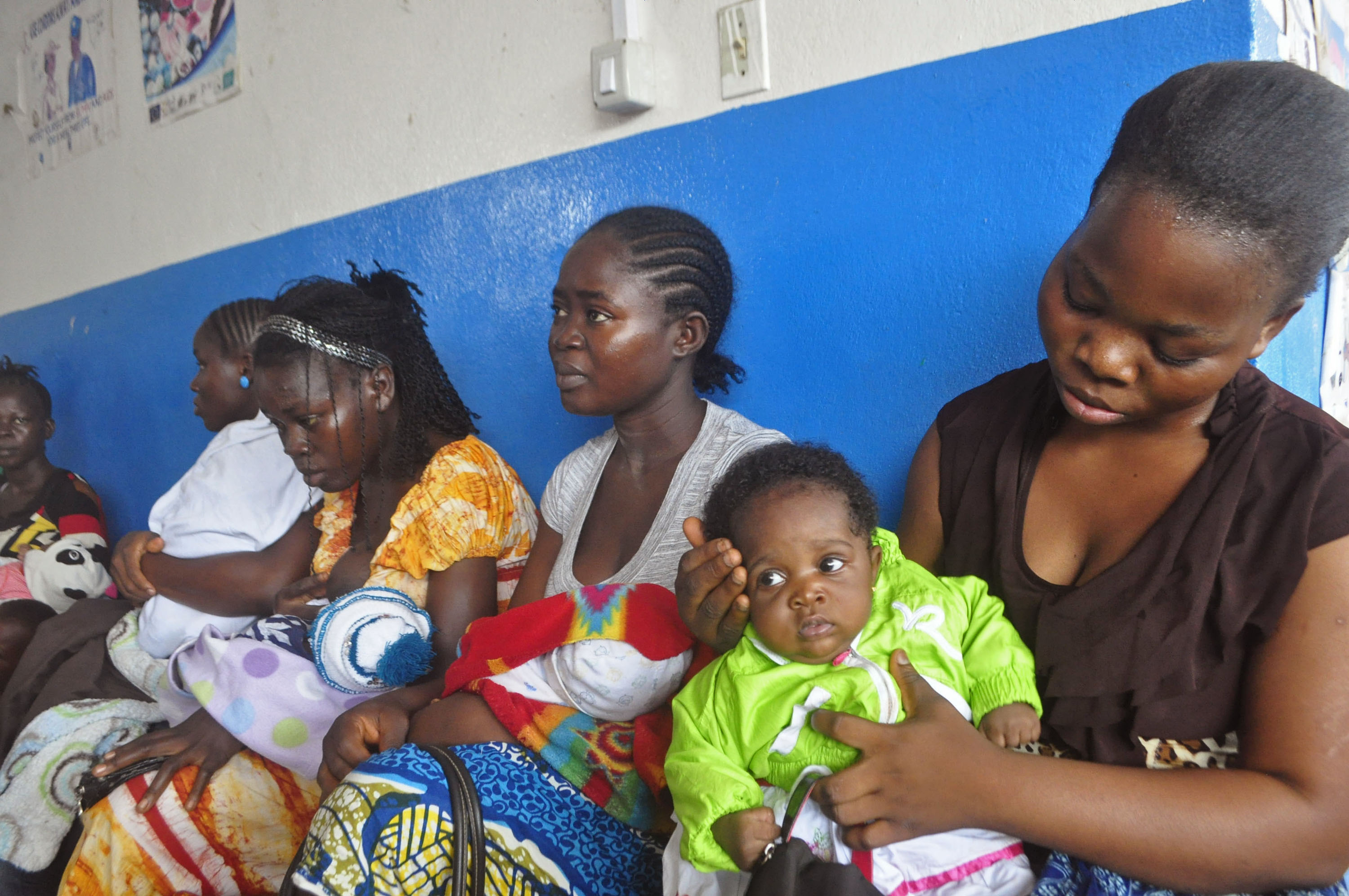 In this photo taken on Monday, Nov. 3, 2014,  mothers wait inline for their children to be vaccinated by heath workers at the Pipeline Community Health Center, situated on the outskirts of  Monrovia, Liberia.  The Ebola outbreak has spawned a silent killer, experts say: hidden cases of malaria, pneumonia, typhoid and the like that are going untreated because people in the countries hardest hit by Ebola either cannot find an open clinic or are too afraid to go to one. (AP/Abbas Dulleh)