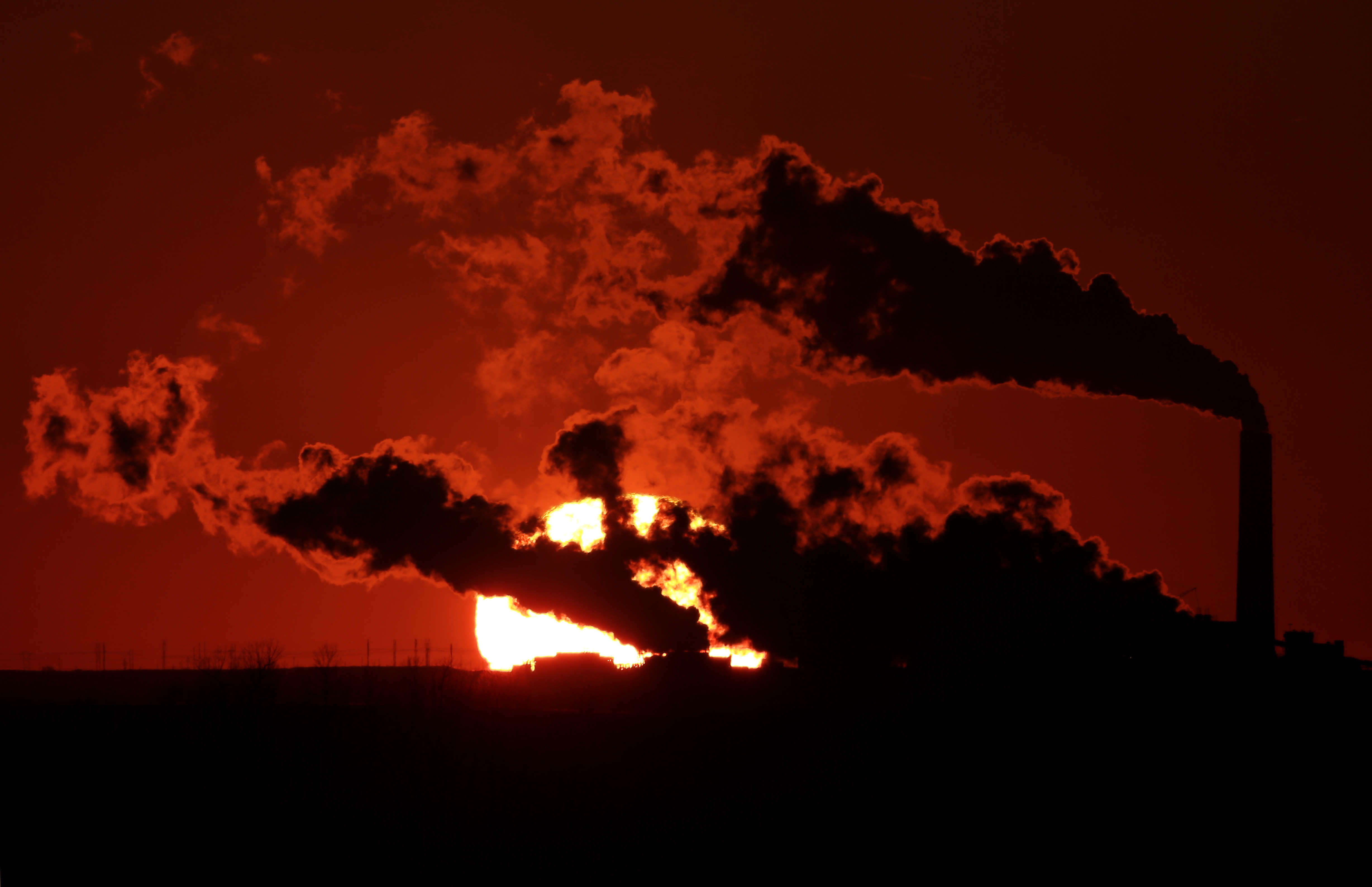 FILE- In this March 8, 2014 file photo, steam from the Jeffrey Energy Center coal-fired power plant is silhouetted against the setting sun near St. Mary's, Kan. A groundbreaking agreement struck Wednesday, Nov. 12, 2014, by the United States and China puts the world's two worst polluters on a faster track to curbing the heat-trapping gases blamed for global warming. Energized by these new targets set by China and the United States, the worlds top climate polluters, U.N. global warming talks resume Dec. 1, 2014 in Peru, with unusual optimism despite evidence that human-generated climate change is already happening and bound to get worse. (AP Photo/Charlie Riedel, File) (AP)