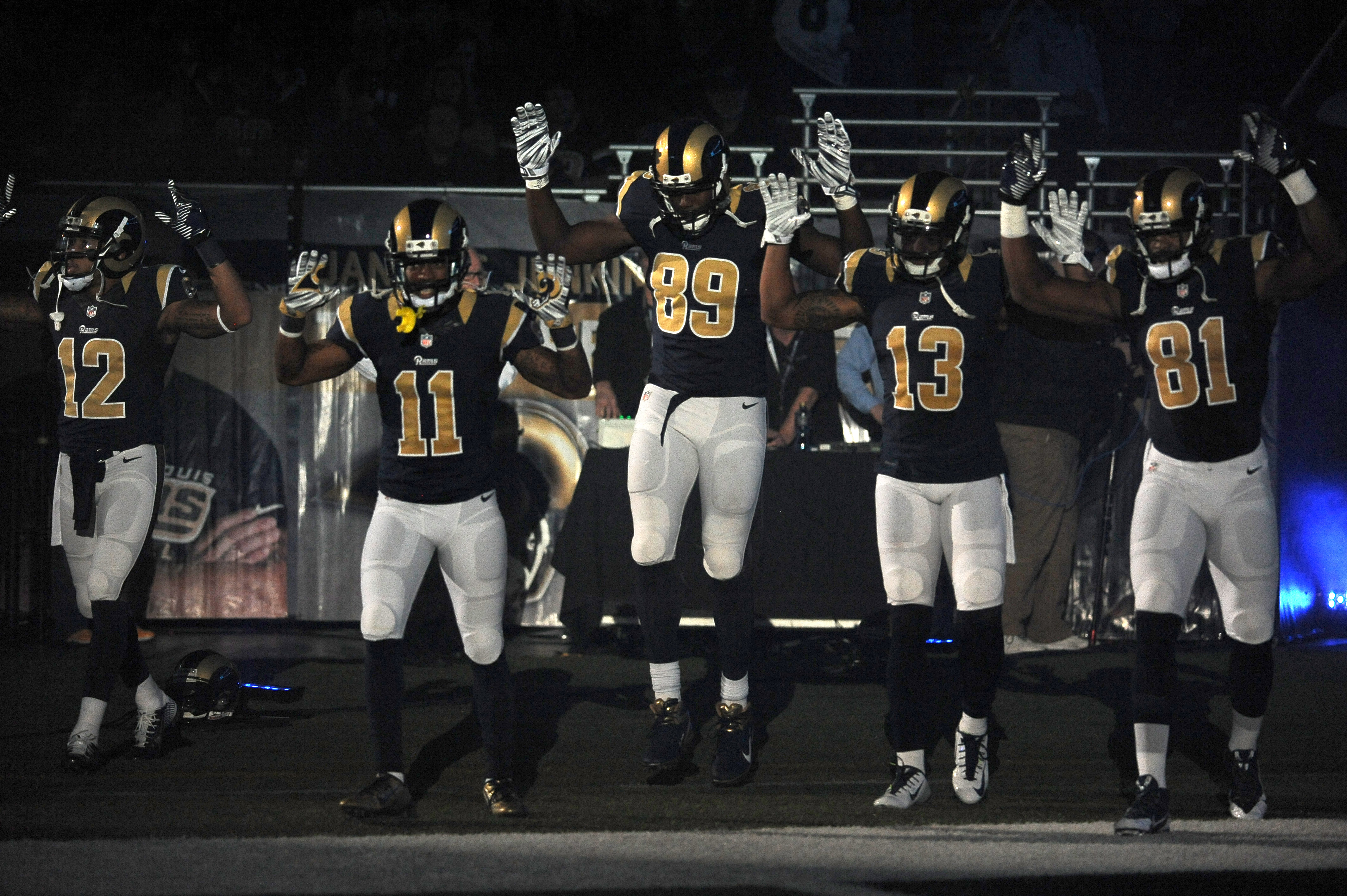 Members of the St. Louis Rams raise their arms as they walk onto the field during introductions before an NFL football game against the Oakland Raiders, Sunday, Nov. 30, 2014, in St. Louis. (AP Photo/L.G. Patterson) (AP)