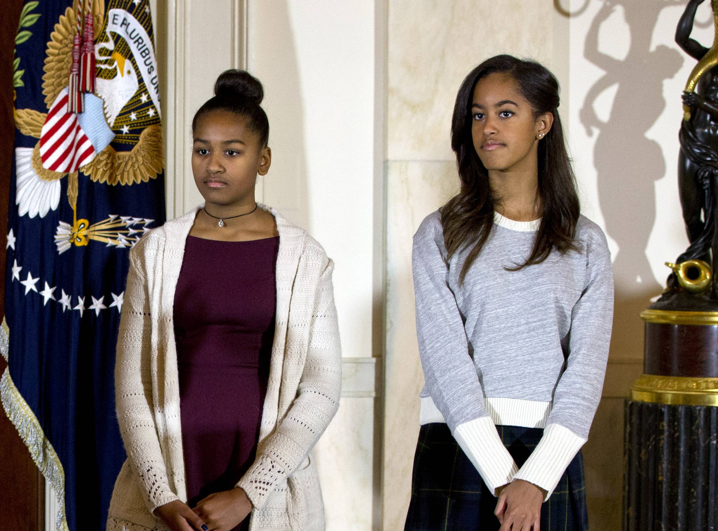 Malia and Sasha Obama at the 2014 presidential turkey pardon ceremony. (Associated Press)
