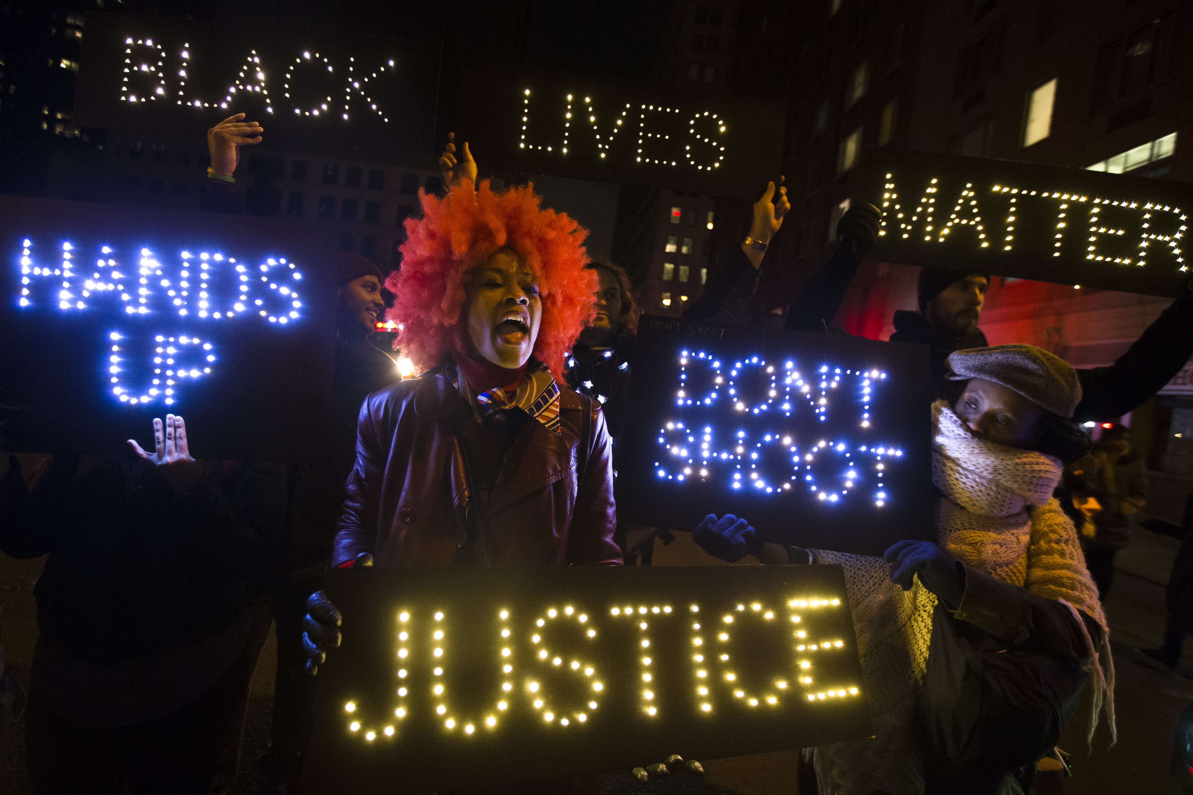 A demonstrator chants during a rally in downtown Manhattan in New York, Saturday, Dec. 13, 2014, during the Justice for All rally and march. In the past three weeks, grand juries have decided not to indict officers in the chokehold death of Eric Garner in New York and the fatal shooting of Michael Brown in Ferguson, Mo. The decisions have unleashed demonstrations and questions about police conduct and whether local prosecutors are the best choice for investigating police. (AP Photo/John Minchillo) (AP)