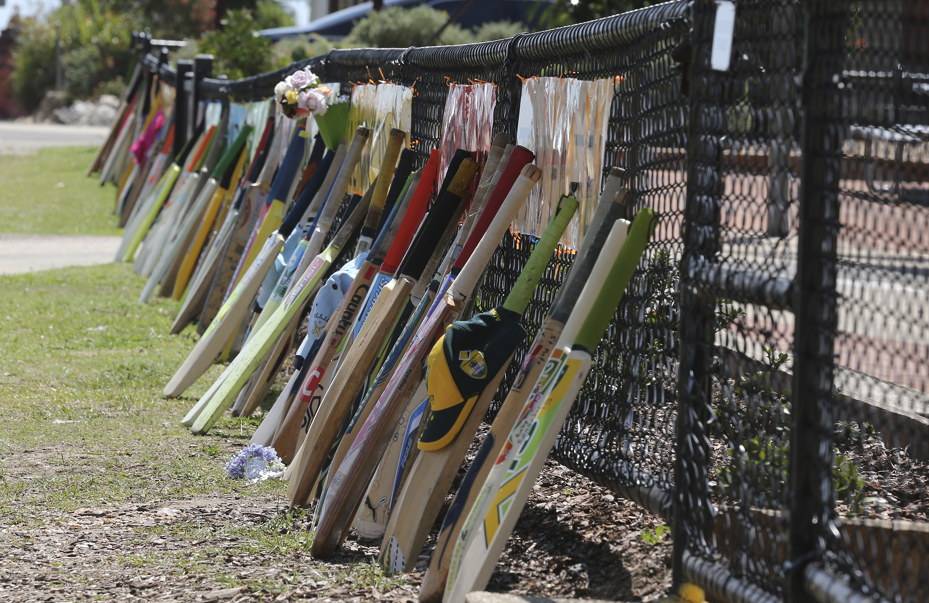 Cricket bat stand as tribute outside a primary school during the funeral of Australian cricketer Phil Hughes in Macksville, Australia, Wednesday, Dec. 3, 2014. Hughes, 25,  died last Thursday, two days after he was hit in the head during a domestic cricket match.(AP Photo/Rob Griffith) (AP)