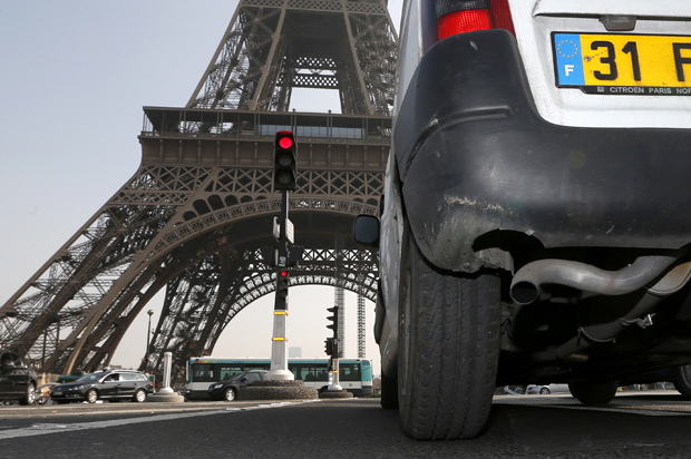 A car drives near the Eiffel tower in Paris, March 14, 2014. (Reuters/Charles Platiau)