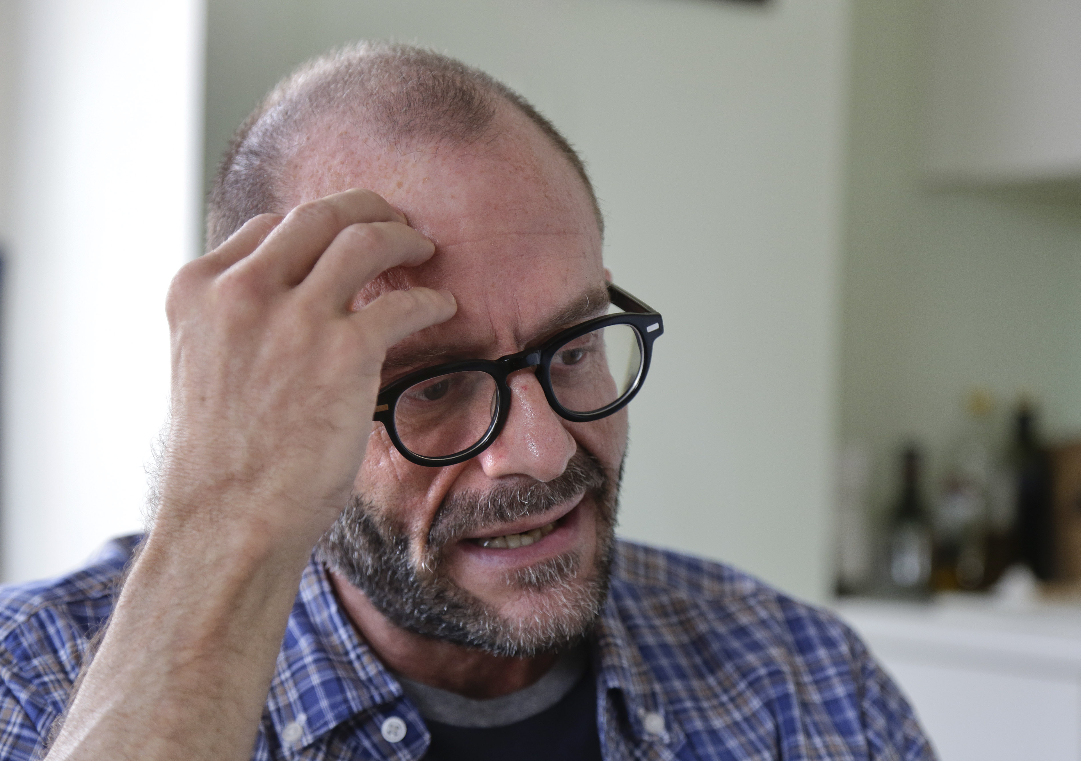 In this Oct. 16, 2014 photo, Jim Albaugh talks about his living arrangements in the New York apartment he shares with two roommates. Albaugh could be thought of as just one of the working poor, untold millions in the baby boomer generation who are not prepared for retirement. But he represents something more as one of thousands of gay and lesbian baby boomers confronting a retirement of greater financial hardship than his straight peers. (AP Photo/Julie Jacobson) (AP)