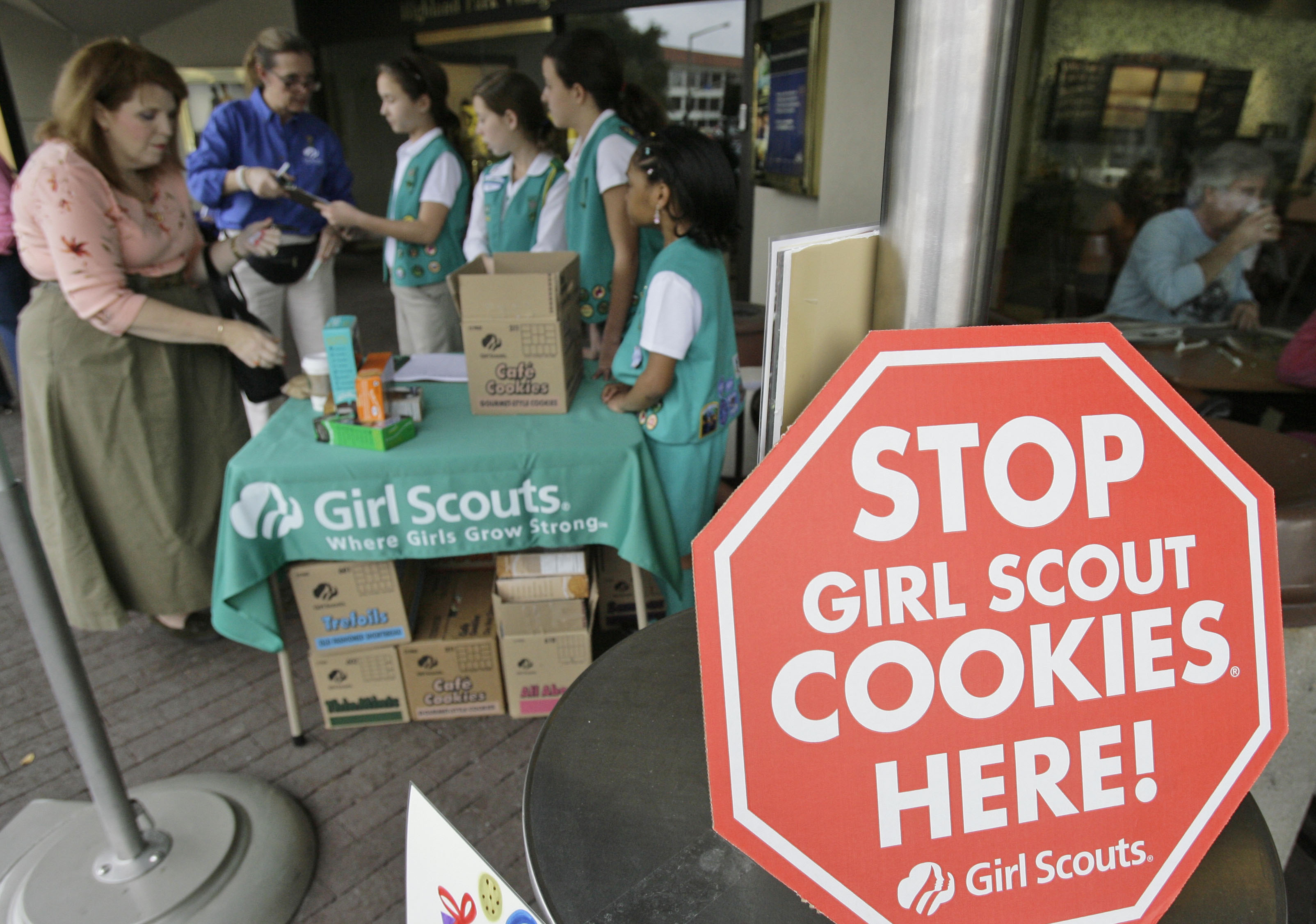 Girl Scouts from the Texas Council sell cookies,  Friday, Feb. 23, 2007, in Dallas. The Girl Scouts have marked their 90th year in the cookie business by getting most of the artificial fat out of all varieties of their iconic treats, which had been under attack by a few health-focused consumer groups. (AP Photo/Matt Slocum) (AP)