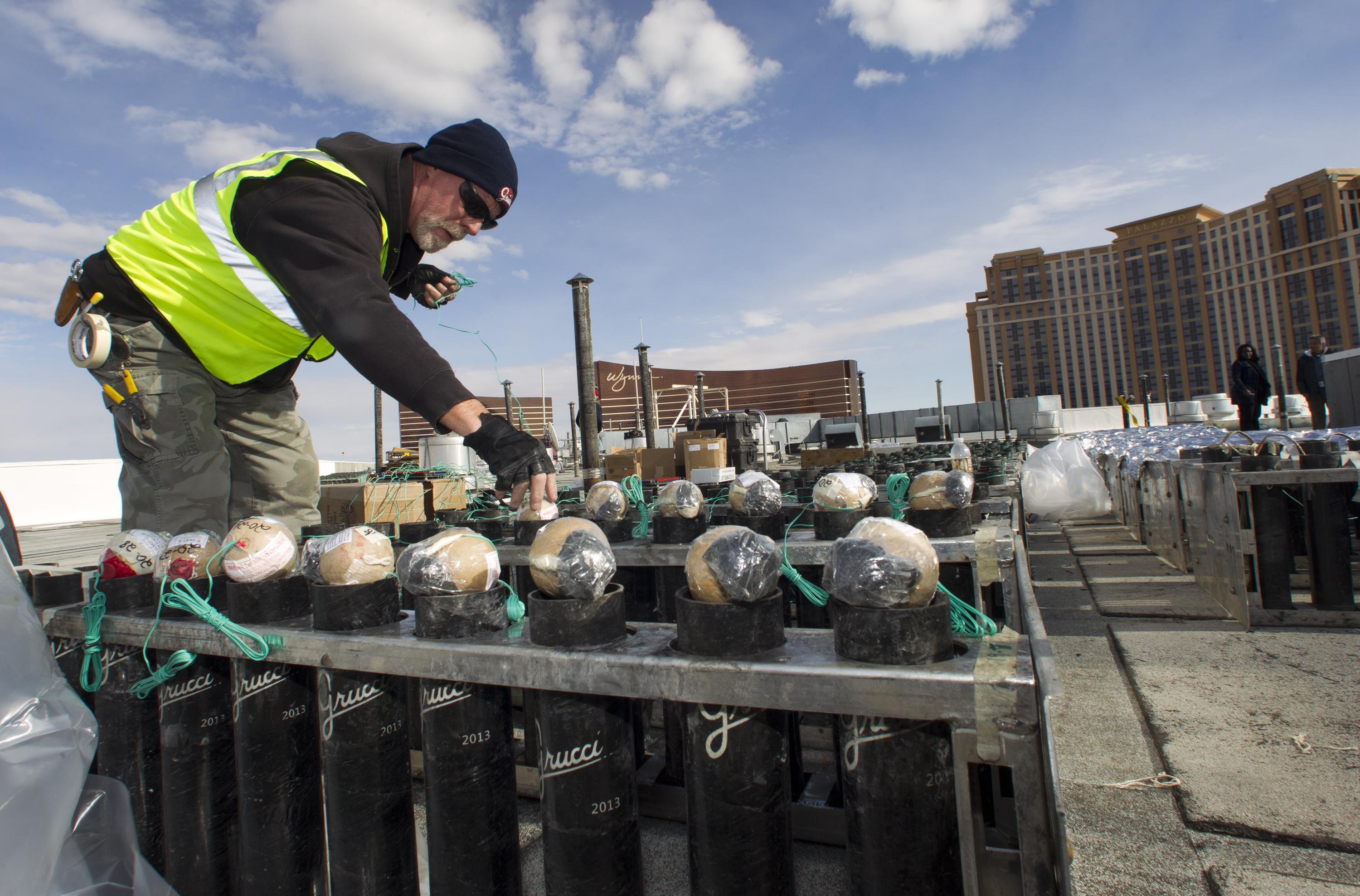 Pyrotechnician Henry Herman loads aerial shells during New Years Eve fireworks preparation on the roof of the Treasure Island hotel-casino in Las Vegas, Tuesday, Dec. 30, 2014. The Fireworks by Grucci show will explode from the rooftops of seven casinos. (AP Photo/Las Vegas Sun, Steve Marcus) (AP)
