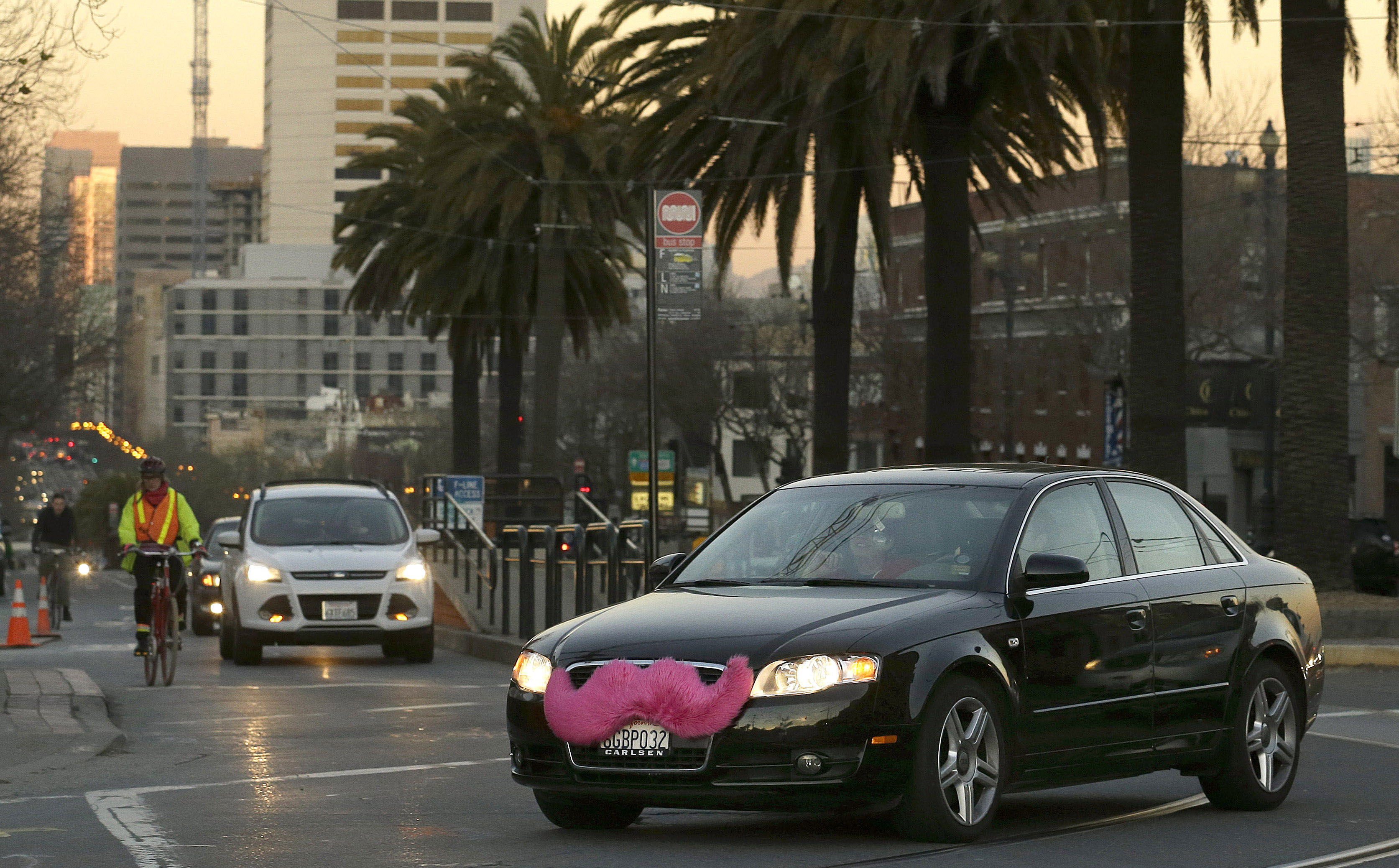 FILE - In this Jan. 17, 2013 file photo, a Lyft car drives crosses Market Street in San Francisco. (AP Photo/Jeff Chiu, File)