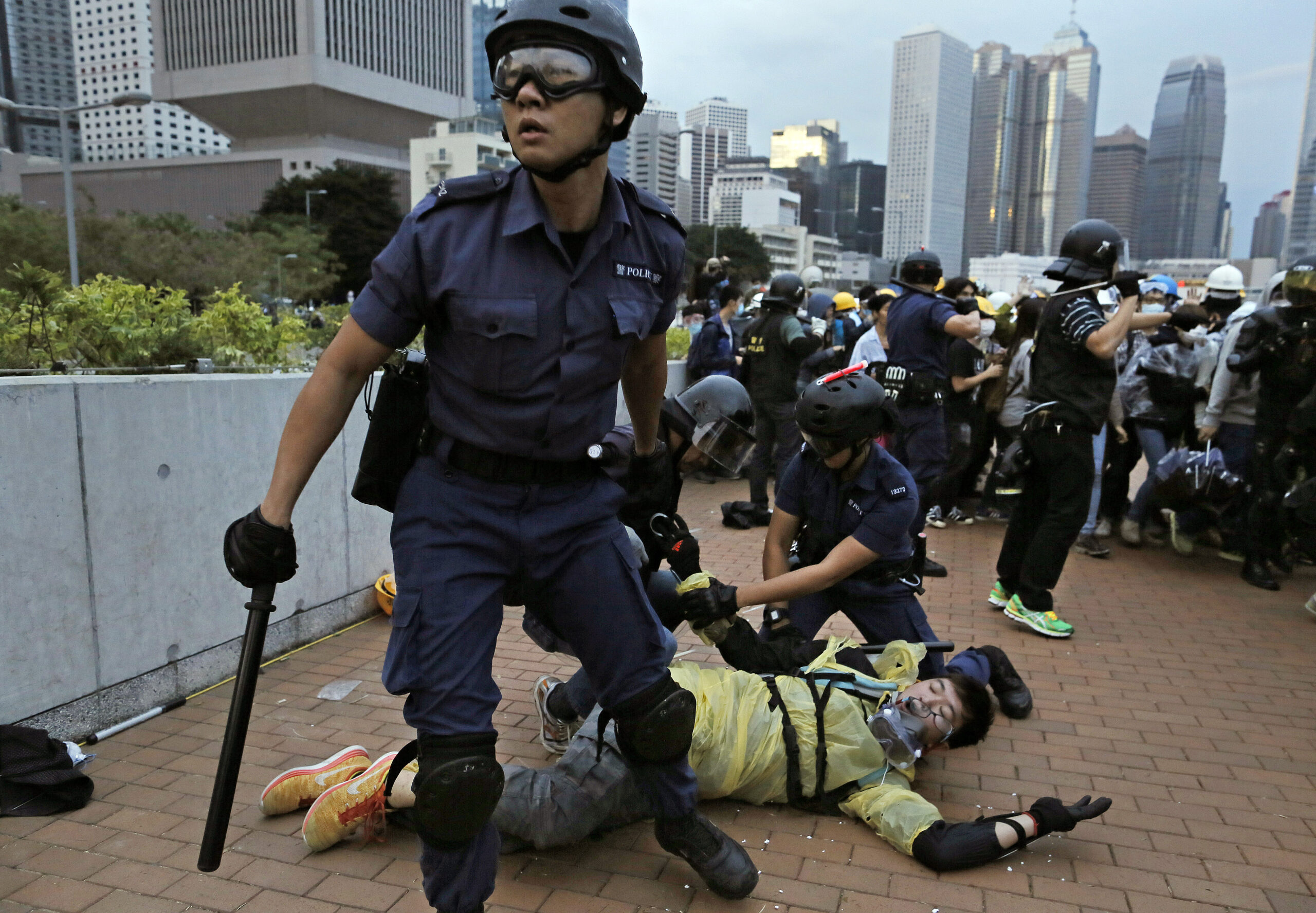 A protester is arrested by police officers outside government headquarters in Hong Kong Monday, Dec. 1, 2014. Pro-democracy protesters clashed with police as they tried to surround Hong Kong government headquarters late Sunday, stepping up their movement for genuine democratic reforms after camping out on the city's streets for more than two months. (AP Photo/Vincent Yu) (Vincent Yu)
