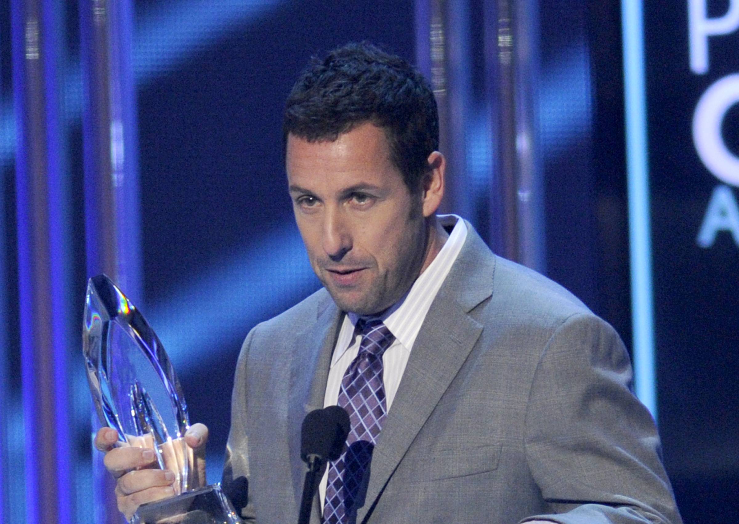 Adam Sandler accepts the award for favorite comedic movie actor at the People's Choice Awards at the Nokia Theatre on Wednesday, Jan. 7, 2015, in Los Angeles. (Chris Pizzello/invision/ap)