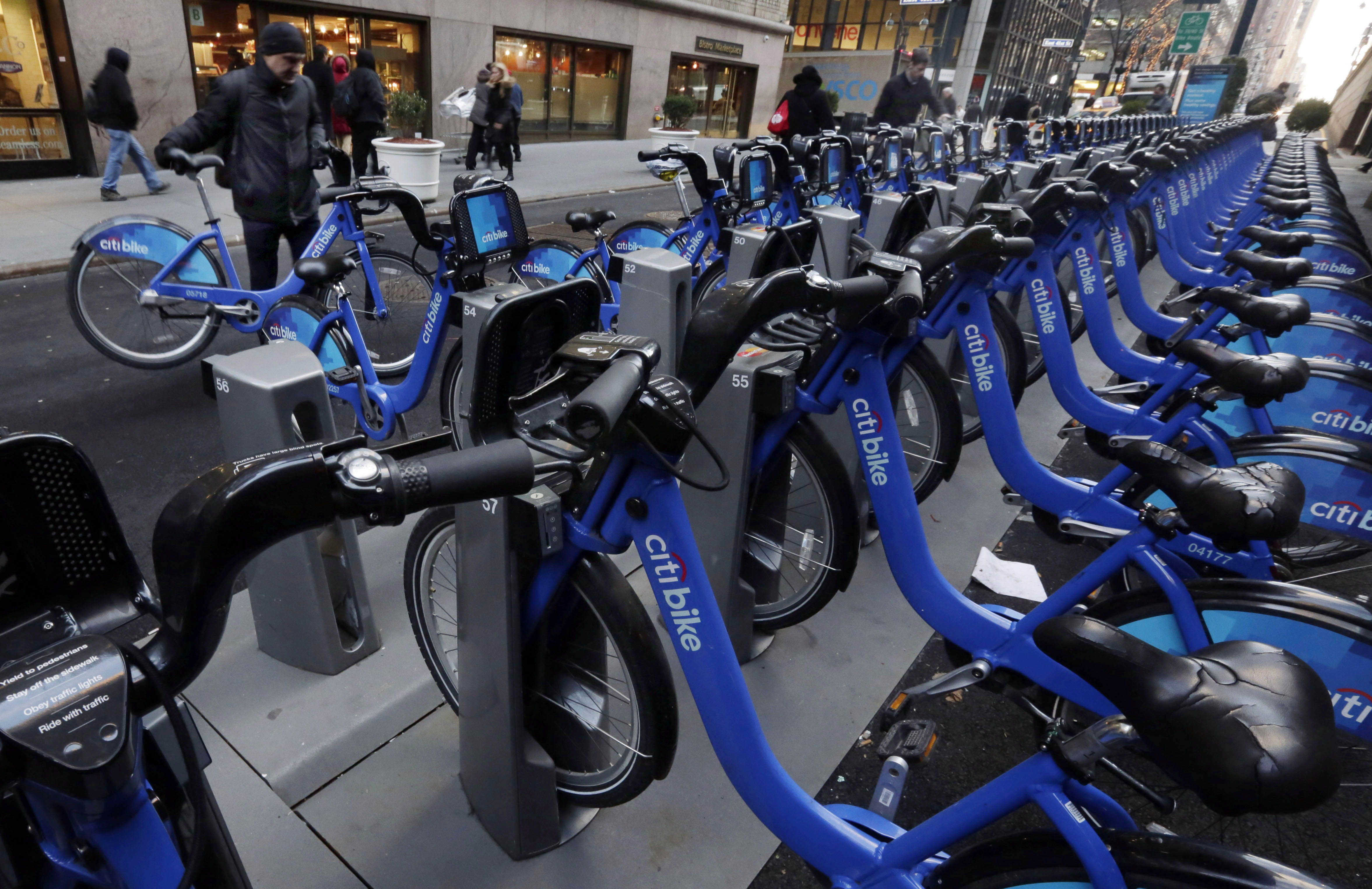 Citbike cyclists pick up their rides near Grand Central Terminal, in New York, Tuesday, Jan. 13, 2015. Now that it has moved from laid-back Portland, Oregon, to amped-up New York, the company that runs bike-sharing programs in New York, Chicago and other major cities is changing its name from Alta Bicycle Share to Motivate. (AP Photo/Richard Drew) (AP)