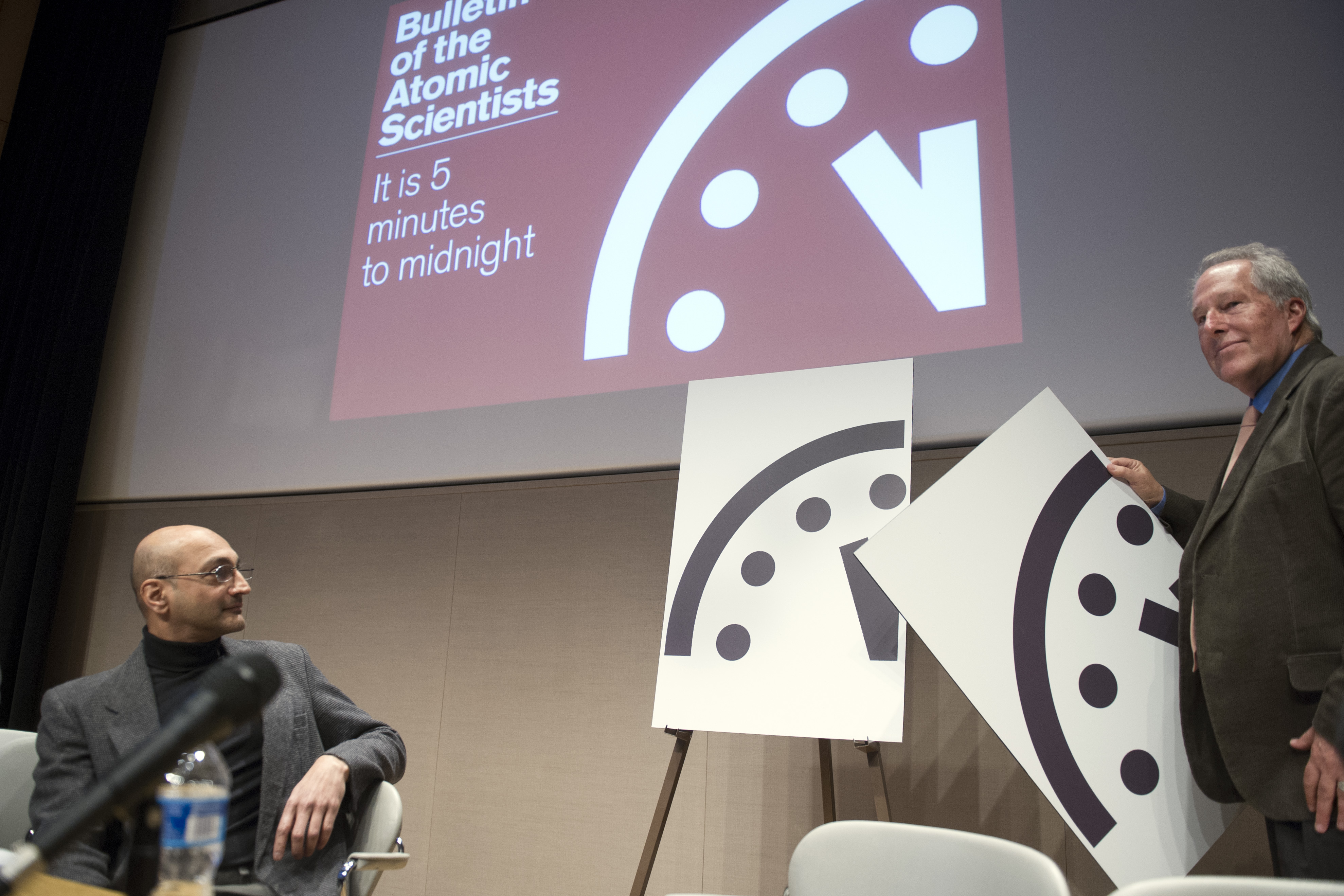Climate scientist Richard Somerville, member, Science and Security Board, Bulletin of the Atomic Scientists, right, unveils the new Doomsday Clock, accompanied by Sivan Kartha, member, Science and Security Board, Bulletin of the Atomic Scientists and senior scientists at the Stockholm Environmental Institute, right, Thursday, Jan. 22, 2015, in Washington. The clock advanced two minutes to midnight, an indication of how near the Earth is to destruction (AP Photo/Cliff Owen) (AP)