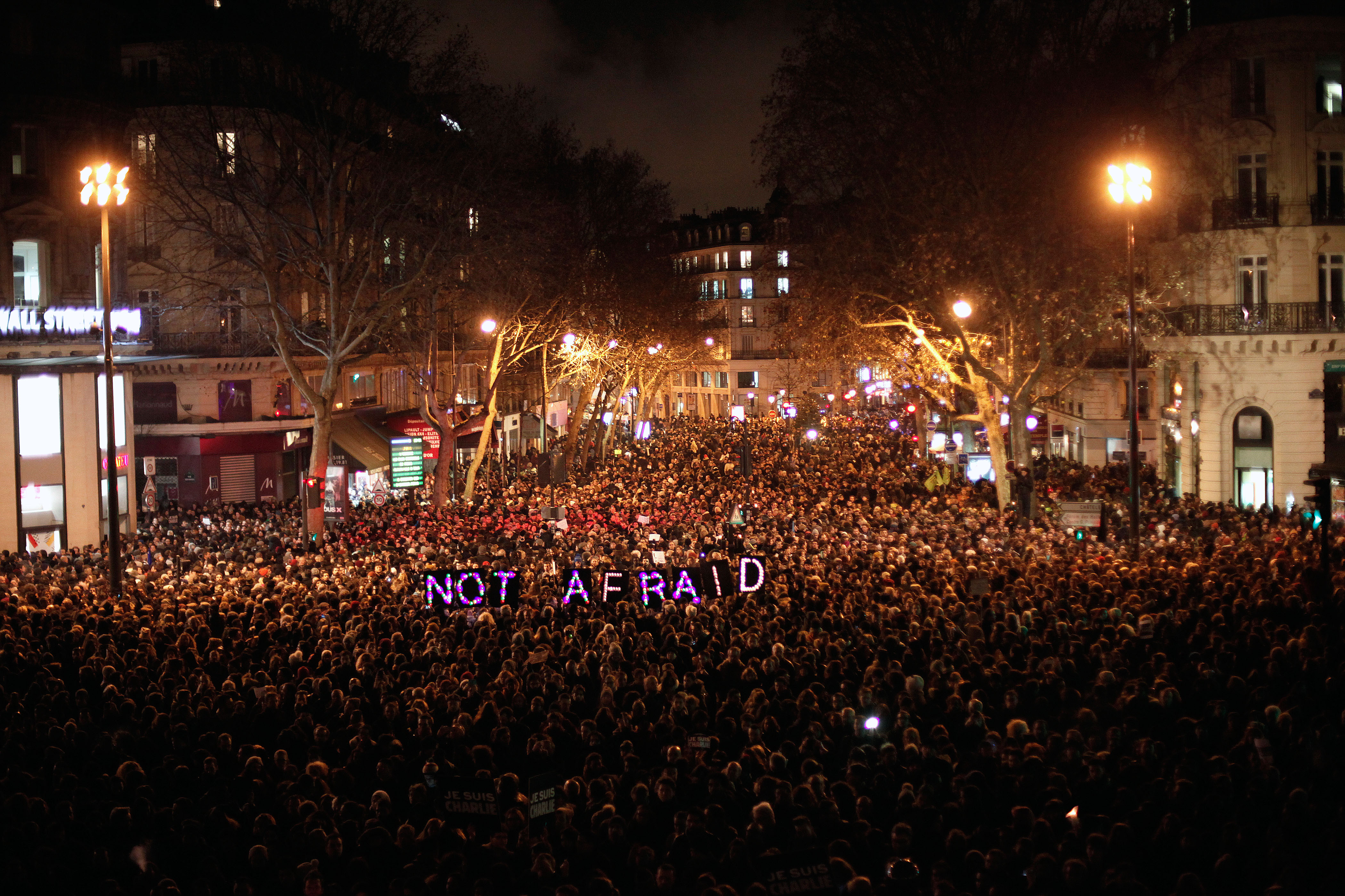 FILE  In this Wednesday, Jan. 7, 2014, file photo, people gather to pay respect for the victims of a terror attack against Charlie Hebdo magazine, in Paris. Masked gunmen shouting "Allahu akbar!" stormed the Paris offices of a satirical magazine killing 12 people, including the paper's editor. (AP Photo/Thibault Camus, File) (AP)