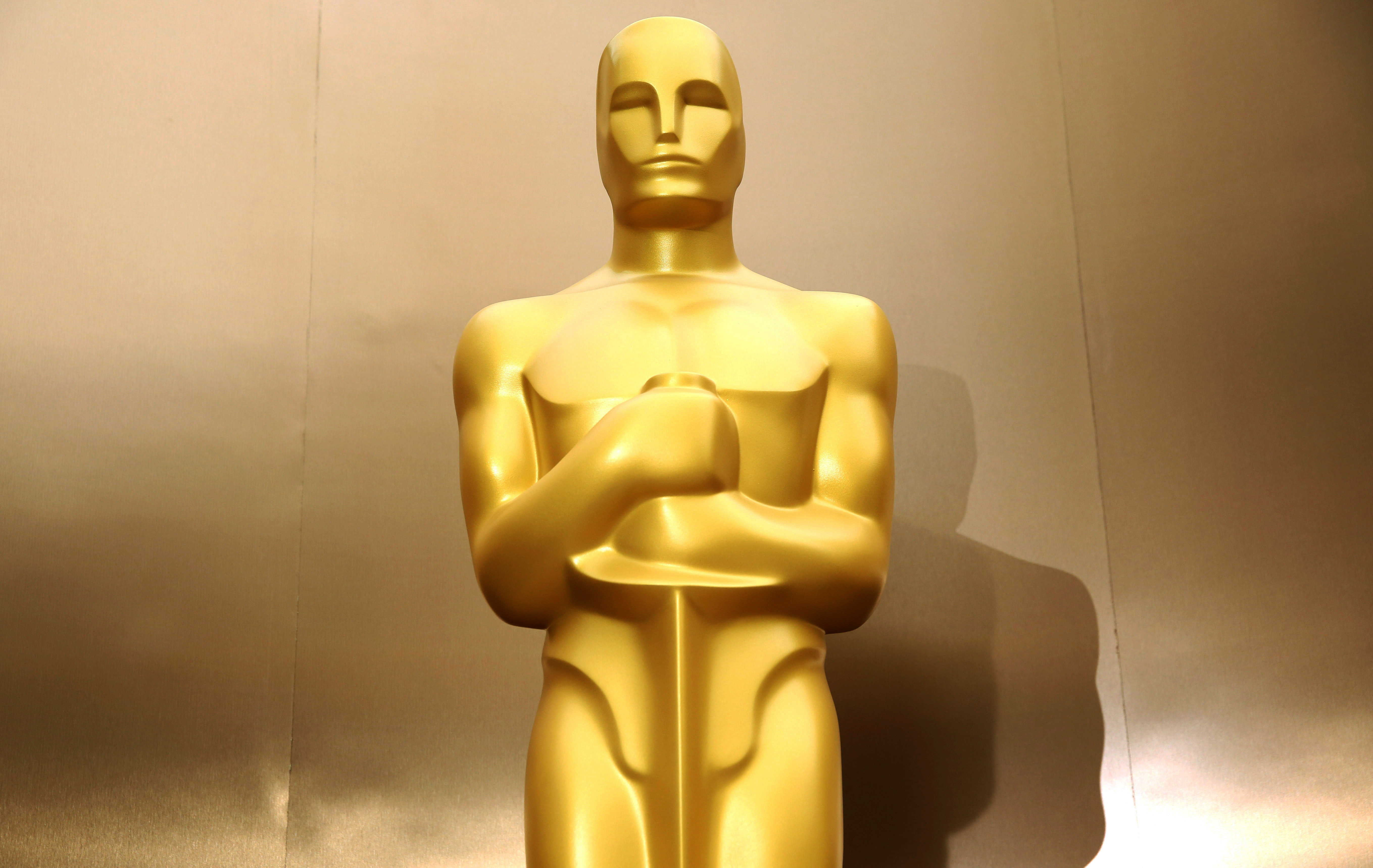 FILE - In this Feb. 28, 2014 file photo, an Oscar statue stands on the red carpet as preparations are made for the 86th Academy Awards in Los Angeles. (Photo by Matt Sayles/Invision/AP, File) (Matt Sayles/invision/ap)