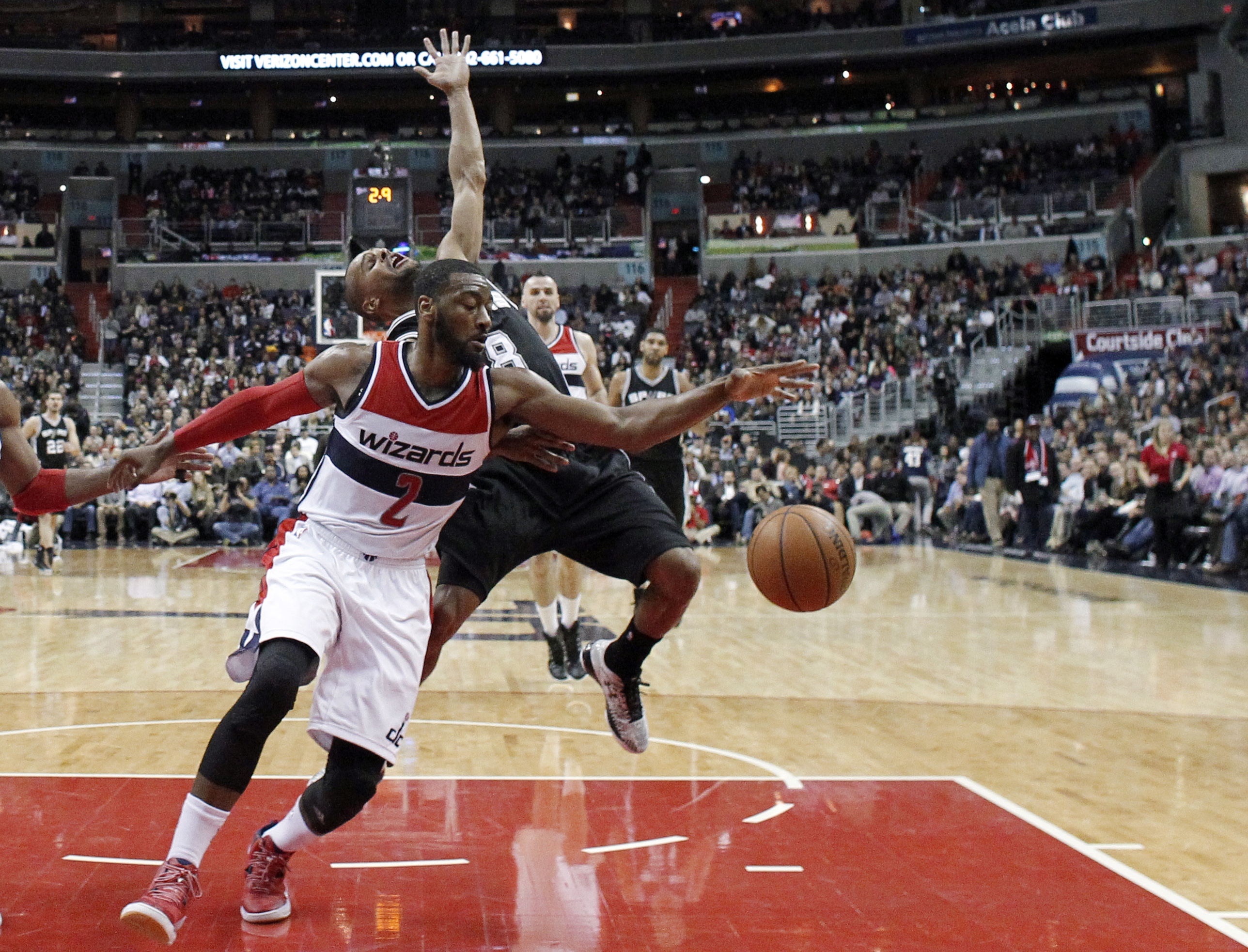 Washington Wizards guard John Wall (2) knocks the ball away from San Antonio Spurs guard Patty Mills (8), from Australia, during the first half of an NBA basketball game, Tuesday, Jan. 13, 2015, in Washington. The Wizards won 101-93. (AP Photo/Alex Brandon) (AP)