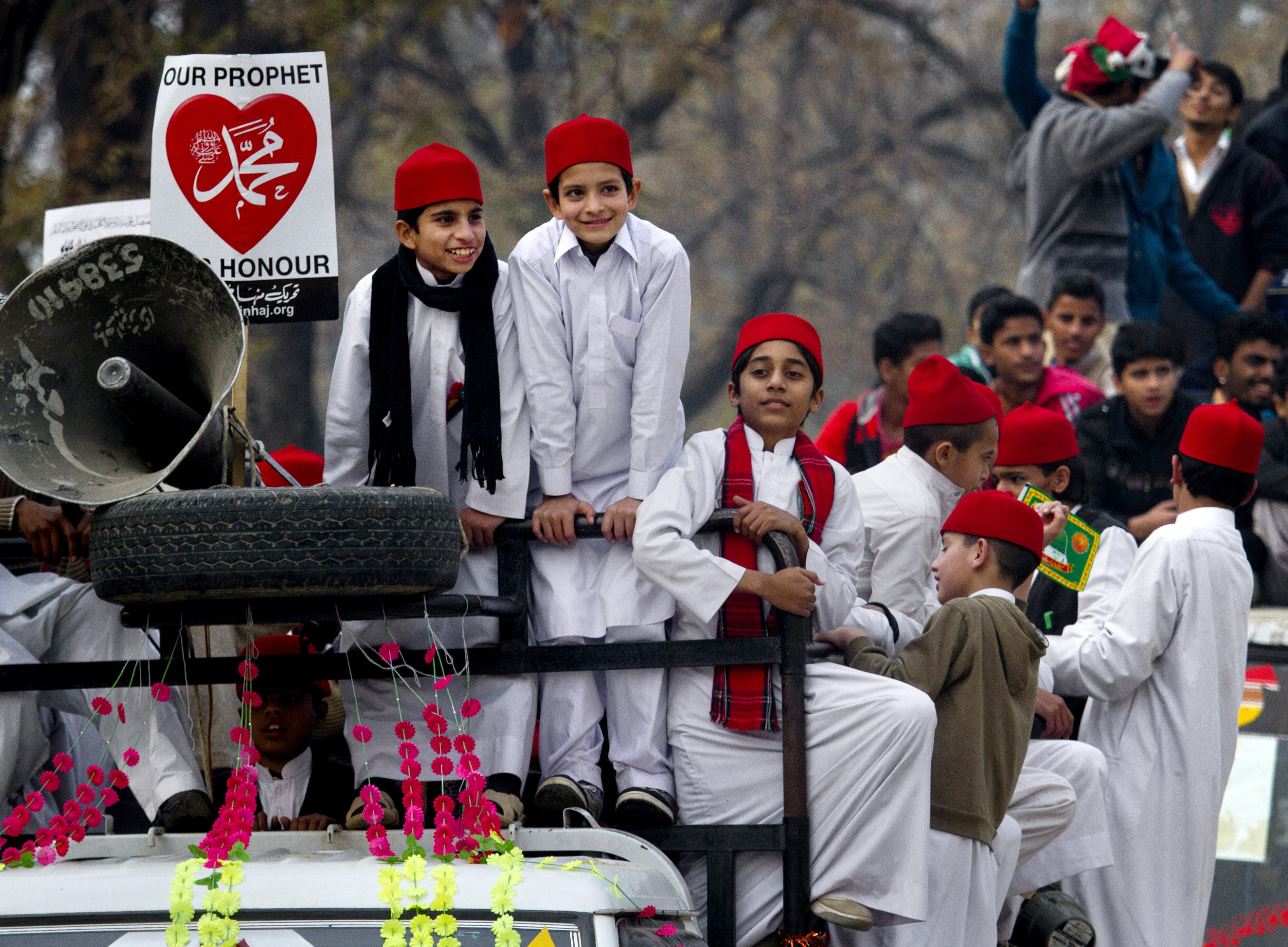 Pakistani boys take part in a rally marking the birthday of Islam's Prophet Muhammad in Islamabad, Pakistan, Sunday, Jan. 4, 2015. Thousands of Pakistani Muslims celebrated by participating in religious ceremonies and distributing free meals for the poor. (AP Photo/Anjum Naveed) (AP)