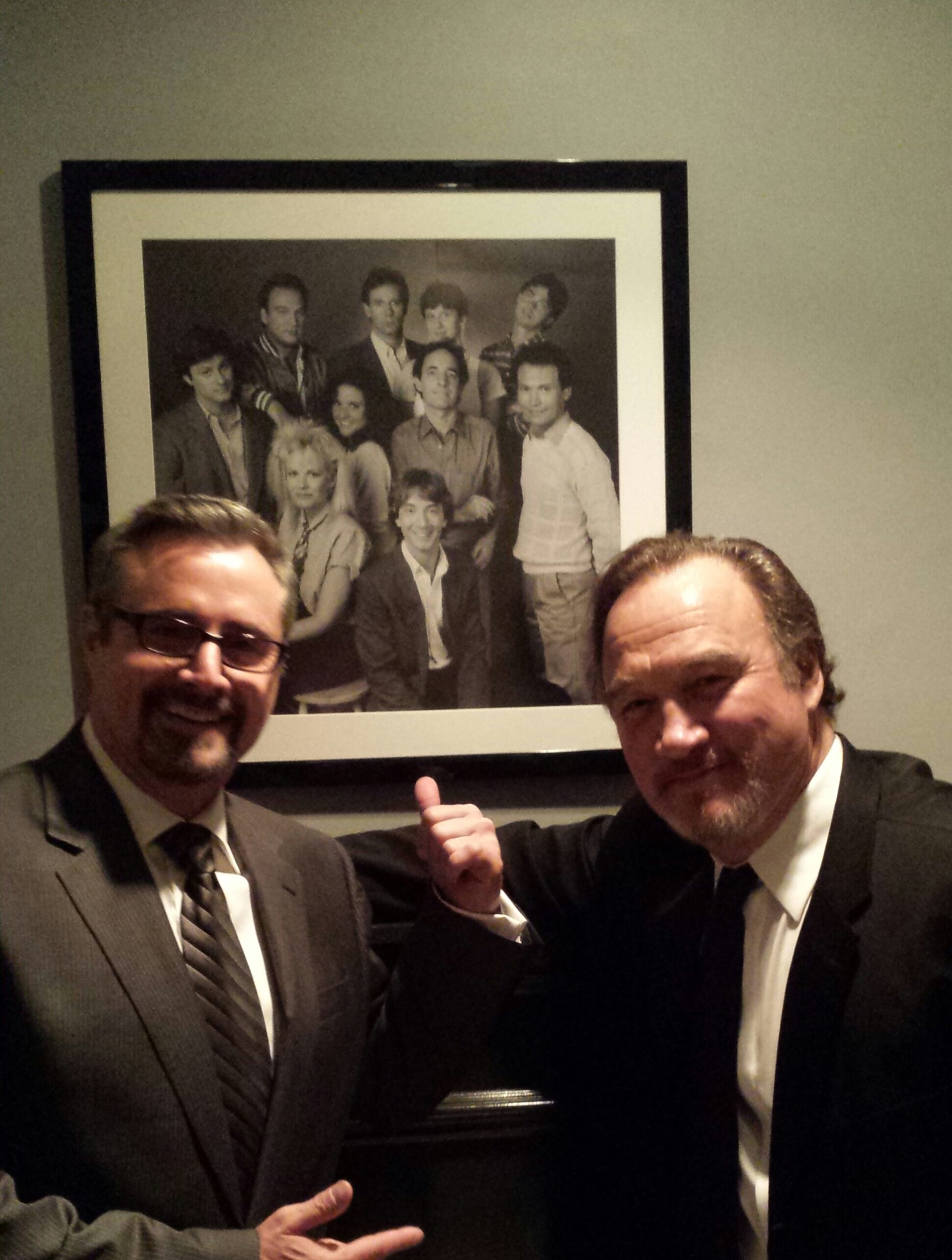 Gary Kroeger and Jim Belushi at 30 Rock, with their cast photo from the 1984-85 season of "SNL" (GaryHasIssues.com)