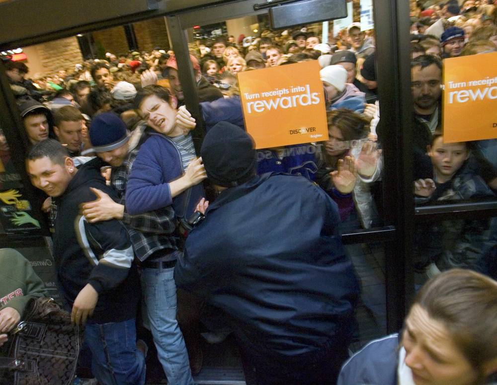 Eager shoppers push through the front doors of the Boise Townsquare mall as they are opened at 1 a.m. Friday in Boise. (Darin Oswald)