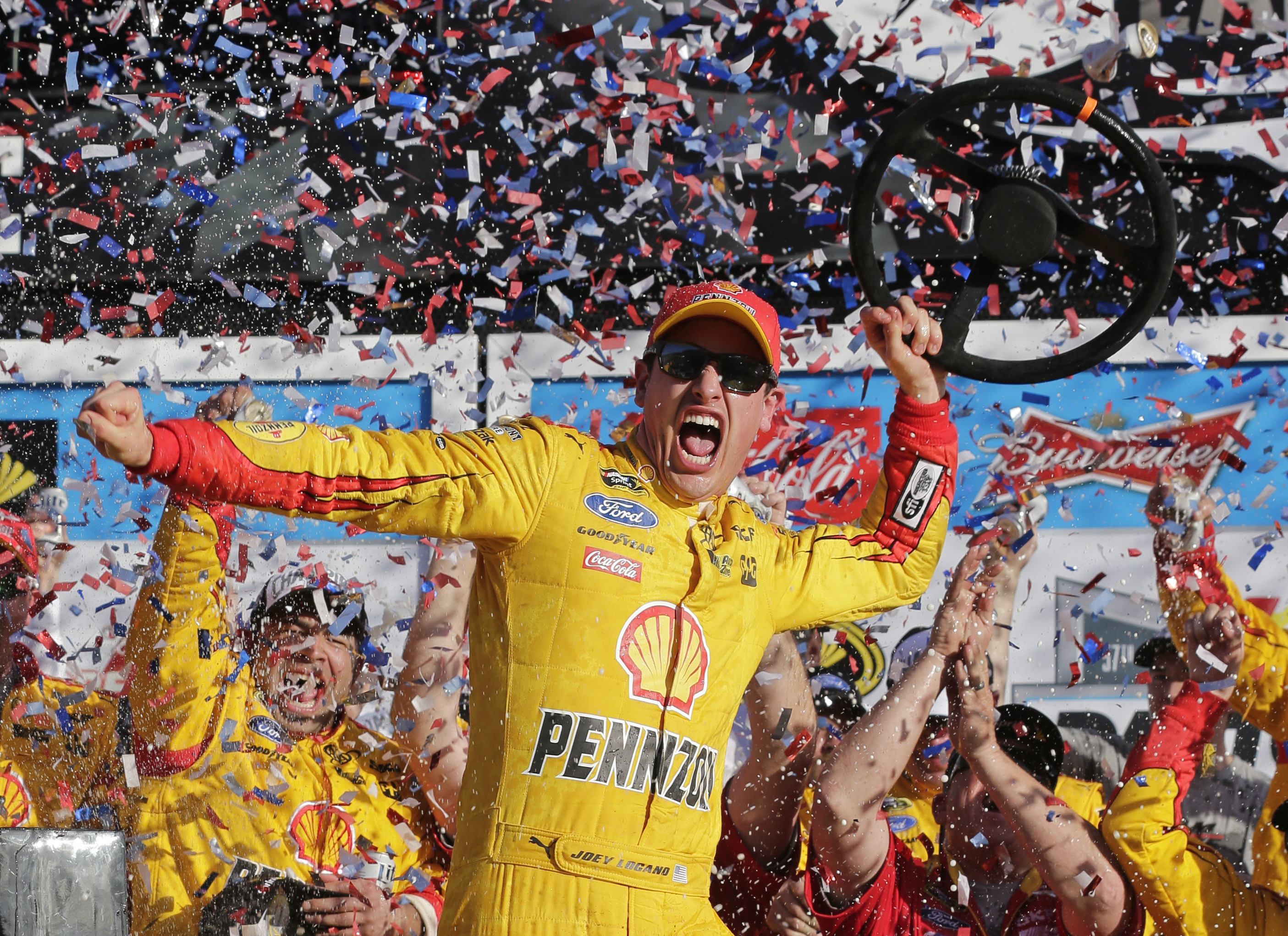 Joey Logano celebrates in Victory Lane after winning the Daytona 500 NASCAR Sprint Cup series auto race at Daytona International Speedway, Sunday, Feb. 22, 2015, in Daytona Beach, Fla. (AP Photo/Chuck Burton) (AP)
