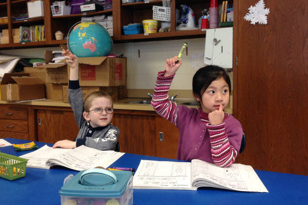 Solomon Zilbershteyn and Yong Lin Li receive language instruction at the Mohegan Elementary School in Montville, Conn. (Michael Melia/AP)