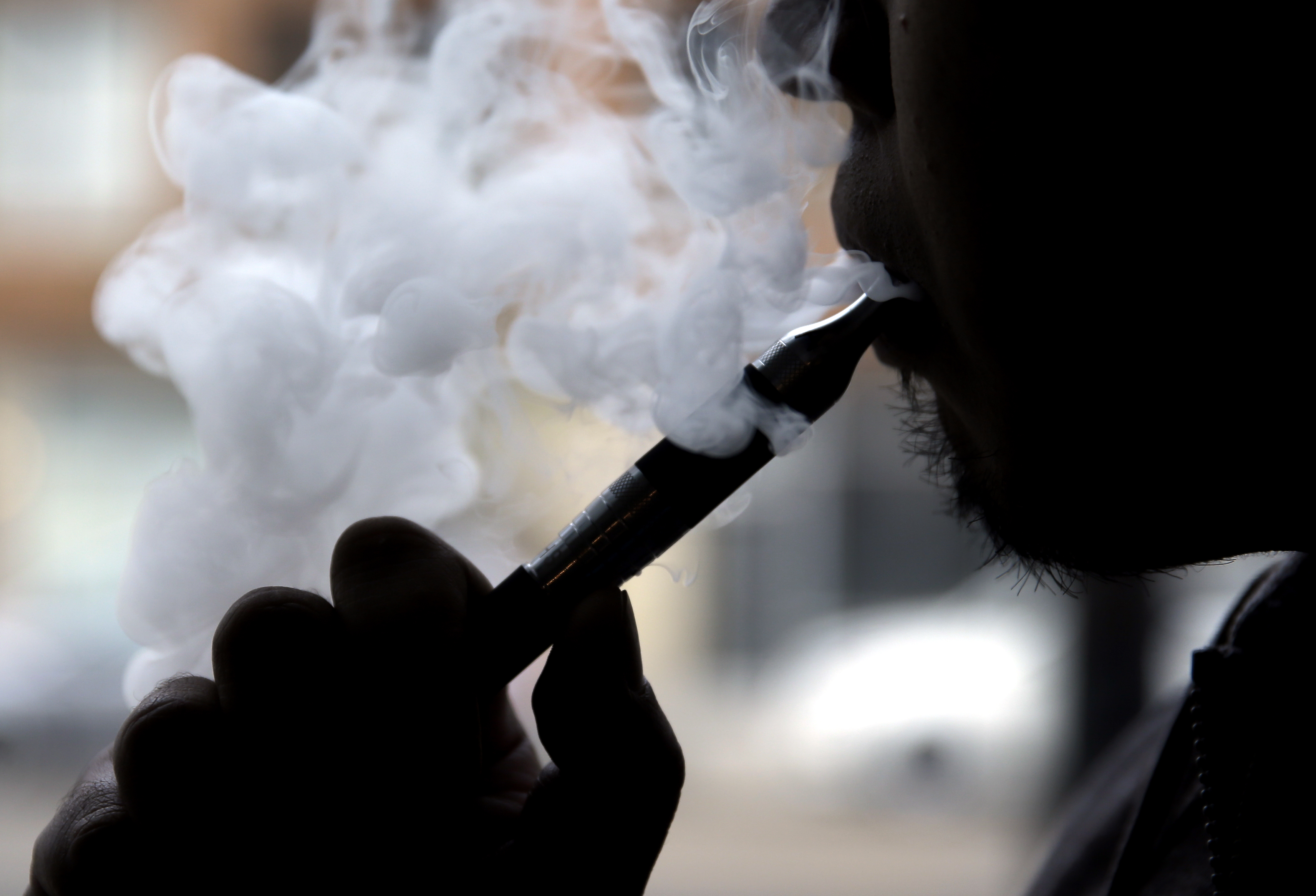 FILE - In this April 23, 2014, file photo, Daryl Cura demonstrates an e-cigarette at Vape Store in Chicago.  (AP Photo/Nam Y. Huh, File) (AP)