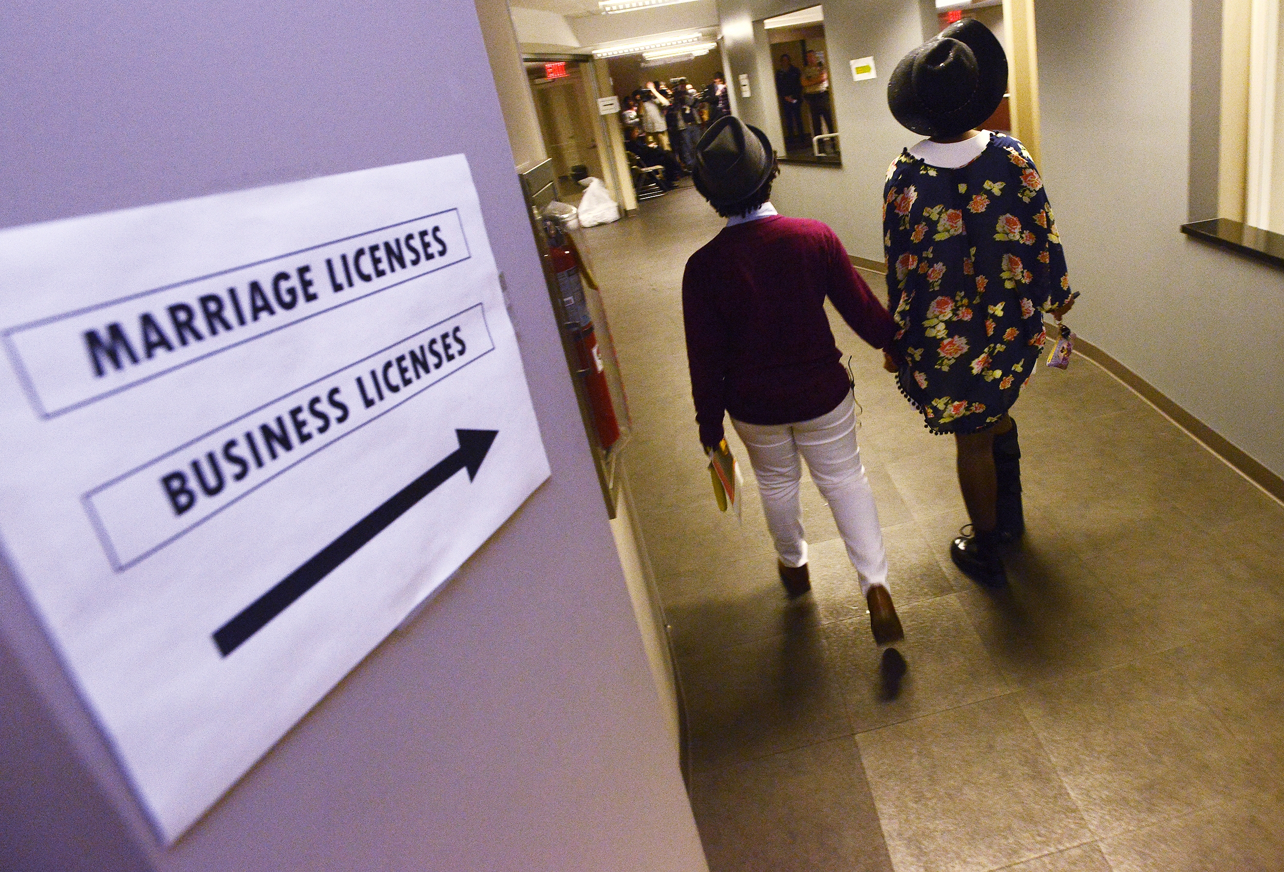 Shante Wolfe, left, and Tori Sisson walk to get their marriage license at the Montgomery County Probate Office in Montgomery, Ala. on Monday, Feb. 9, 2015. (AP/Montgomery Advertiser, Mickey Welsh)