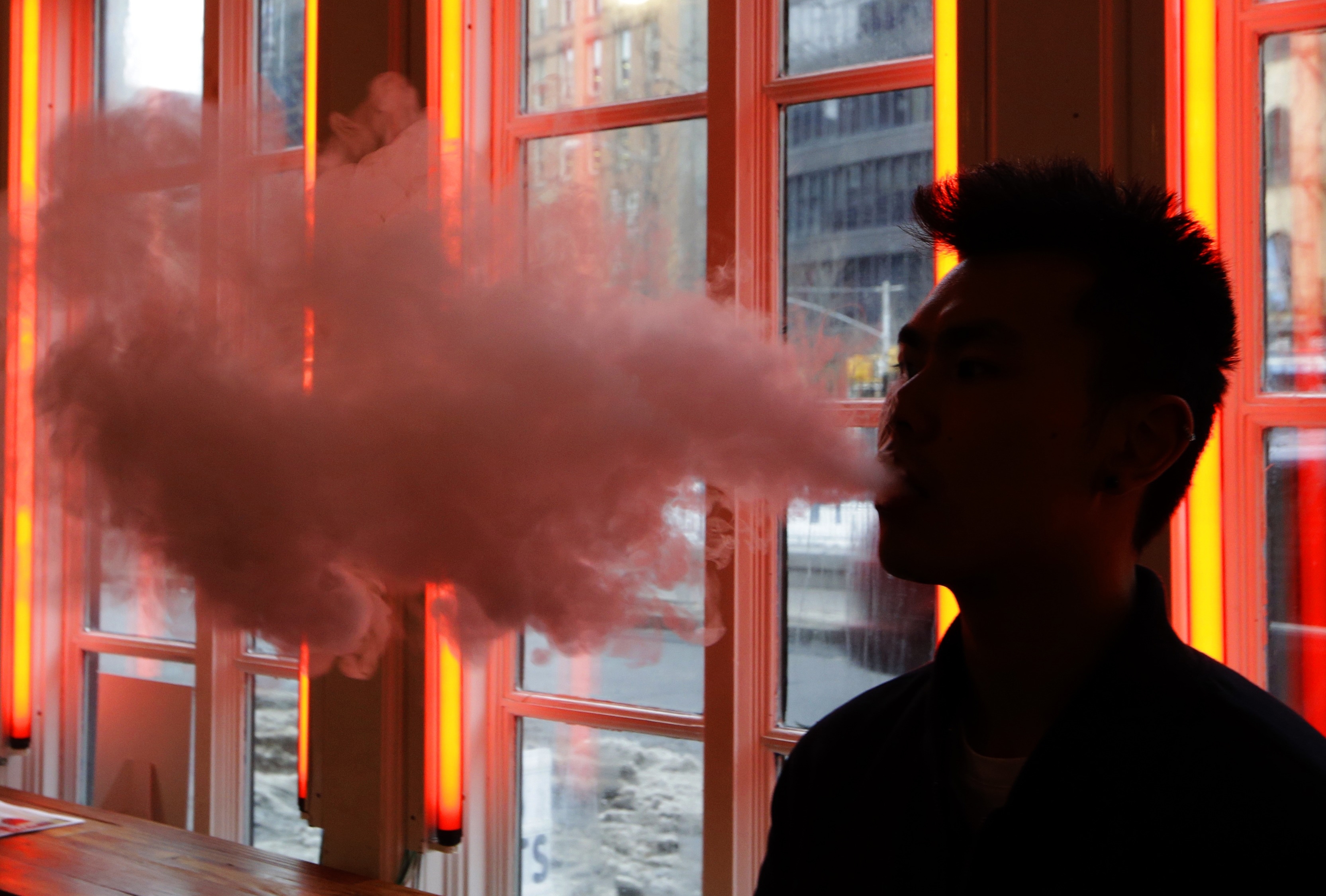 FILE - In this Feb. 20, 2014, File photo, a patron exhales vapor from an e-cigarette at the Henley Vaporium in New York. The first peek at a major study of how Americans smoke suggests many use combinations of products, and often e-cigarettes are part of the mix. It's a preliminary finding, but it highlights some key questions as health officials assess electronic cigarettes. (AP Photo/Frank Franklin II, File) (AP)