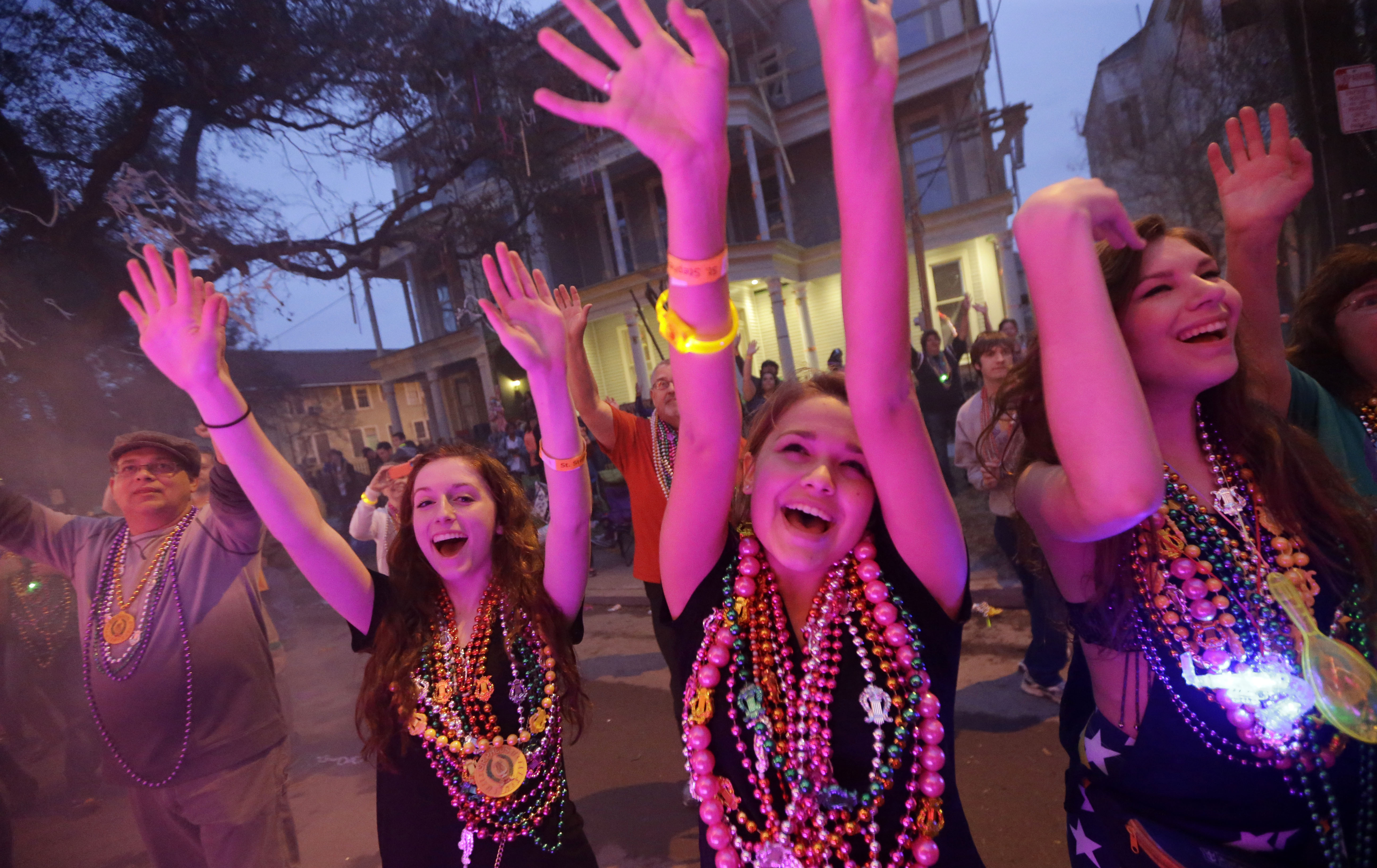 Parade-goers vie for beads and trinkets during the Krewe of Proteus Mardi Gras parade in New Orleans, Monday, Feb. 16, 2015. The day is known as Lundi Gras, the day before Mardi Gras. () (AP Photo/Gerald Herbert)