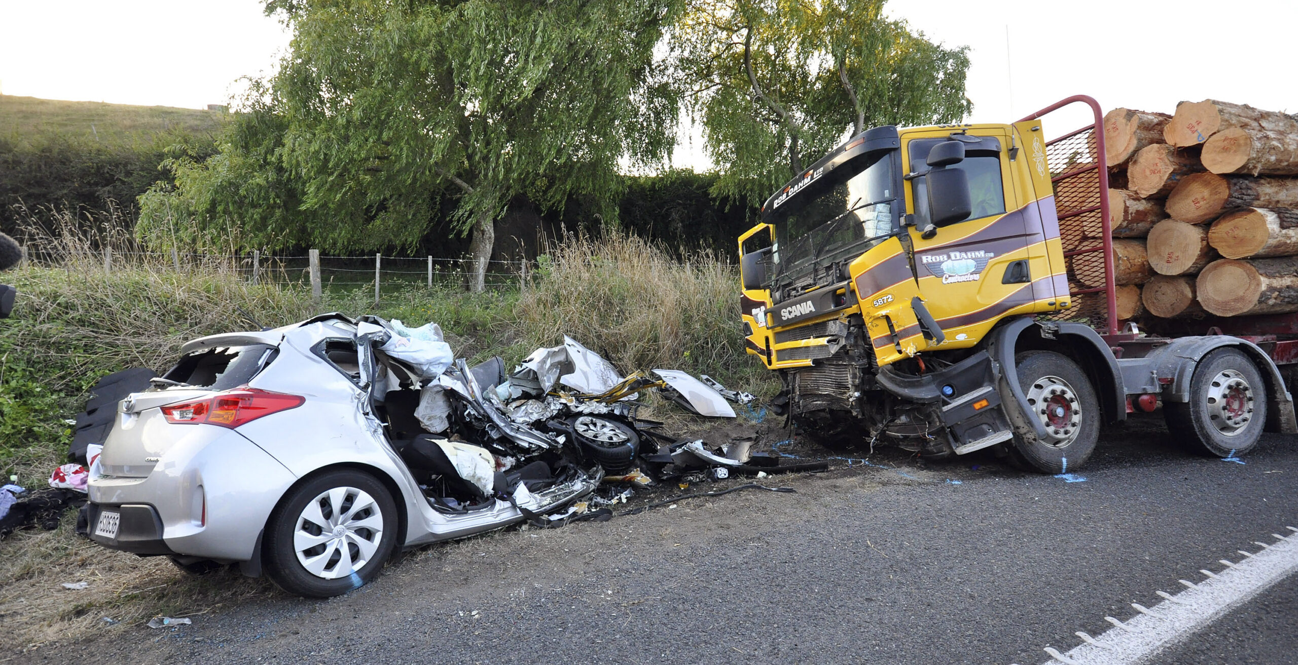 A small passenger car and a logging truck as seen after they collided head-on near Tokoroa, New Zealand, Tuesday Feb.  2015. Authorities said, U.S. citizens  Warren Lee, 53, and his wife Aesoon Lee, 52 and the couple's 20-year-old daughter, Julia Lee, were killed and their son critically injured when their car crashed into a logging truck.(AP Photo/NZ Herald/John van de Ven)**Australia Out New Zealand Out** (John Van De Ven)