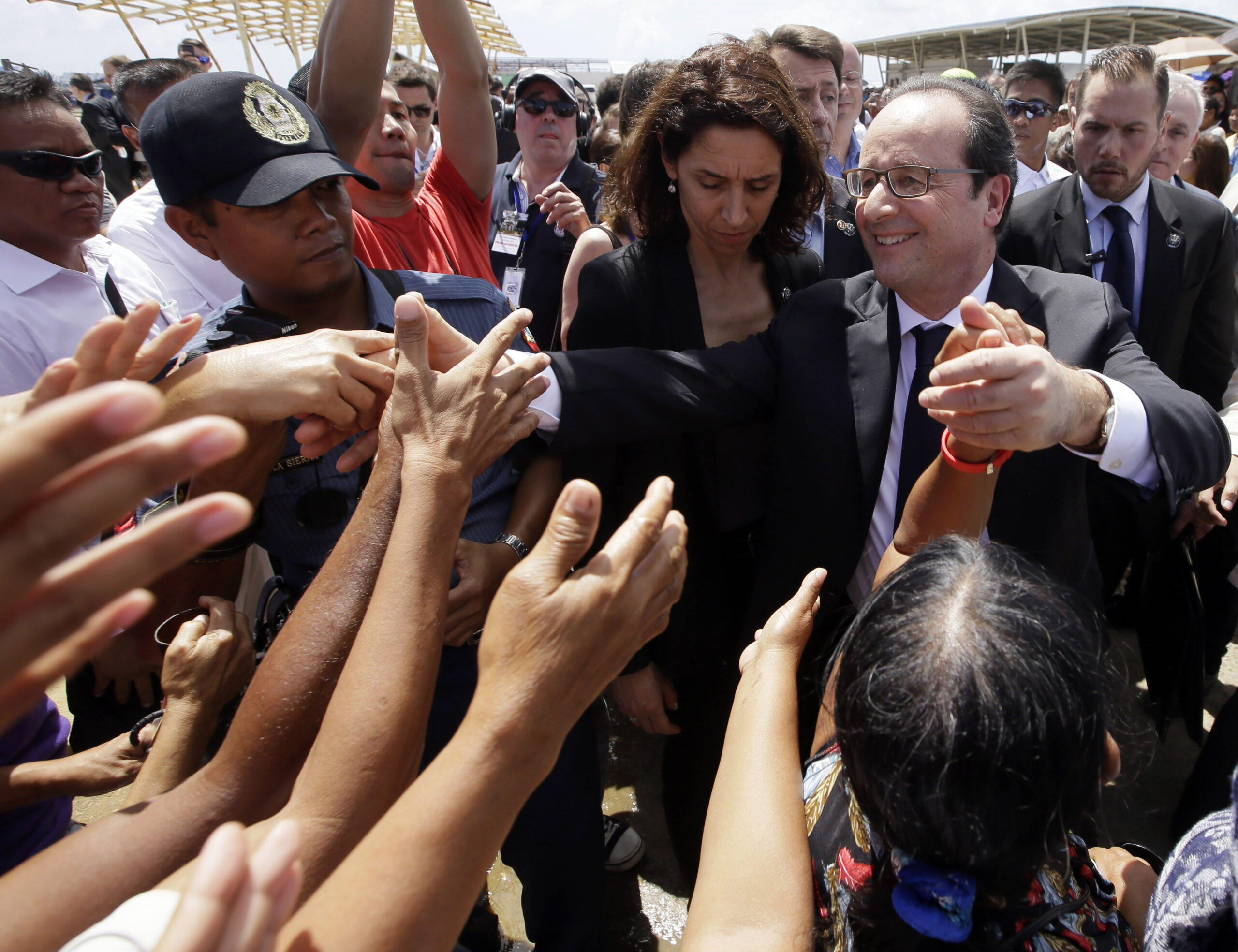 President Francois Hollande of France is greeted by the crowd during his visit to the  typhoon-ravaged Guiuan township, Eastern Samar province in central Philippines Friday, Feb. 27, 2015. Hollande's two-day state visit focuses on climate change.(AP Photo/Bullit Marquez) (Bullit Marquez)