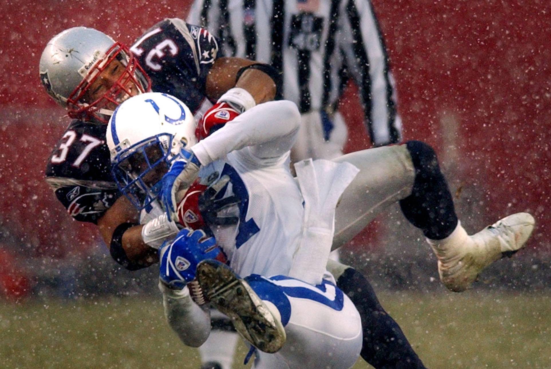 New England Patriots safety Rodney Harrison (37) takes down Indianapolis Colts wide receiver Reggie Wayne (AP/Charles Krupa)