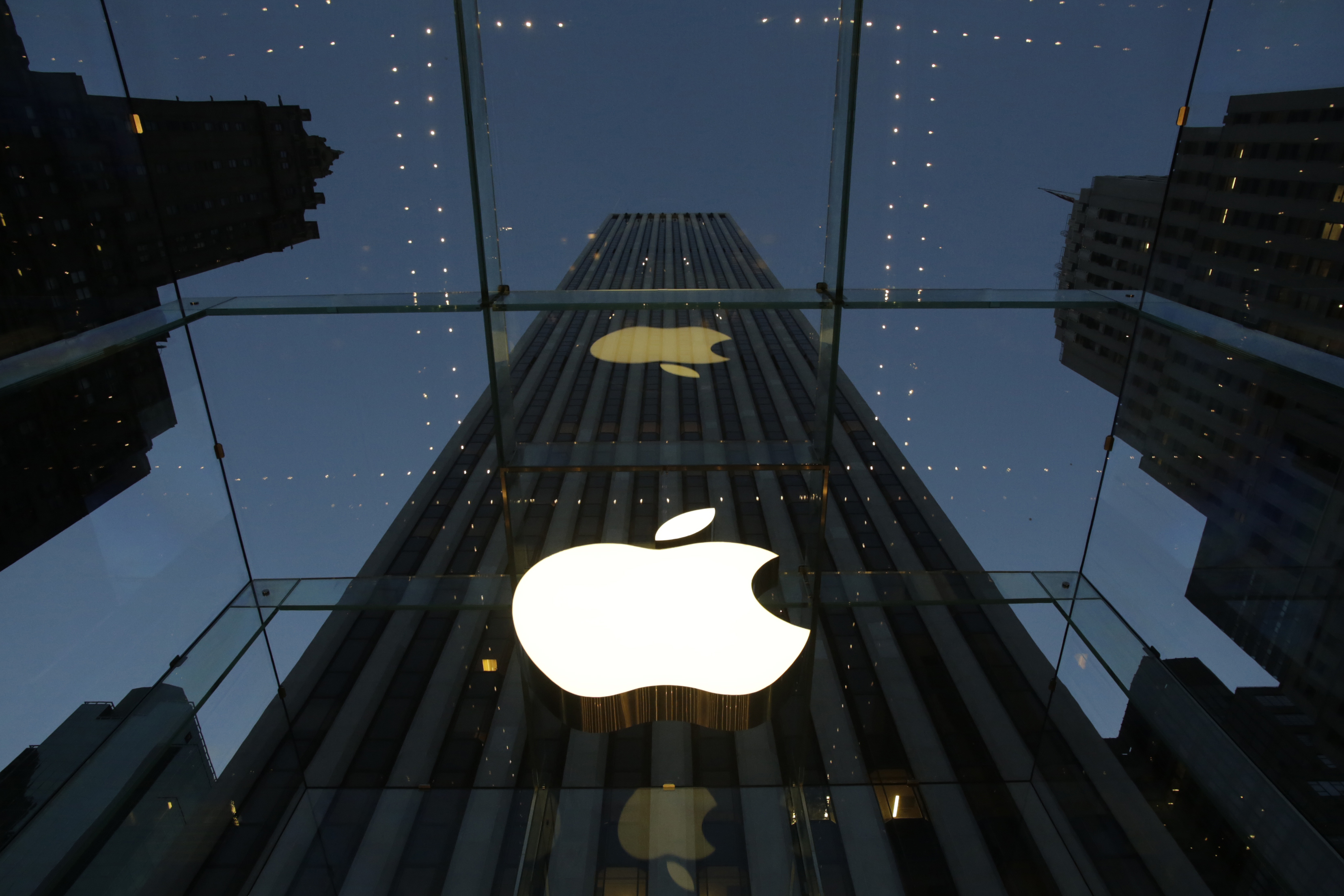 FILE - In this Wednesday, Nov. 20, 2013, file photo, the Apple logo is illuminated in the entrance to the Fifth Avenue Apple store, in New York. Apples widely used iTunes and app stores suffered a rare breakdown Wednesday, March 11, 2015, frustrating millions of music lovers and mobile device owners around the world. (AP Photo/Mark Lennihan, File) (AP)