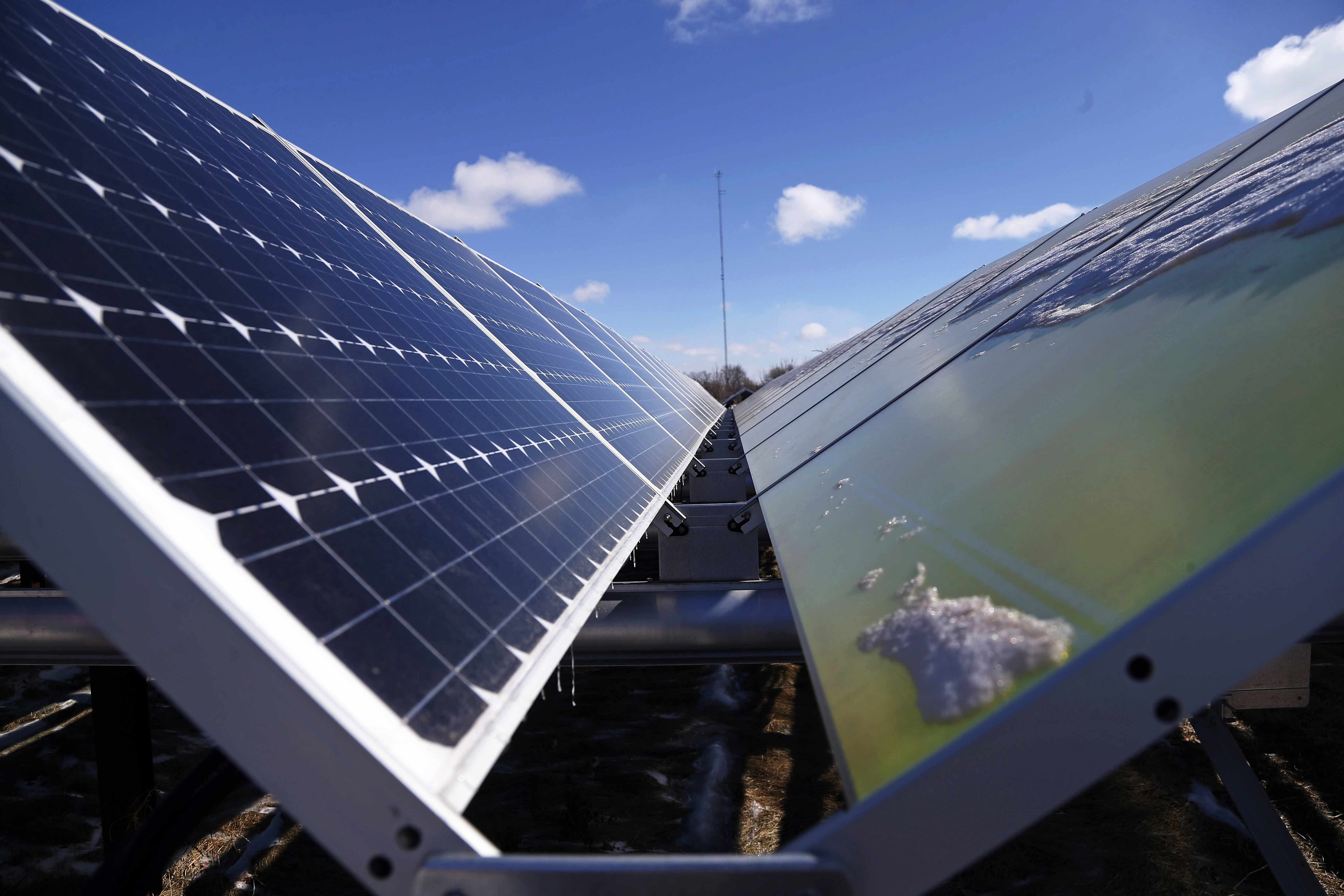 In this Feb. 26, 2015 photo, solar panels that are part of the Wright-Hennepin Cooperative Electric Association's community gardens are shown in Rockford, Minn. Community solar gardens are a new concept in renewable energy, allowing customers who cannot put up solar panels to buy into the green energy boom anyway. (AP Photo/Jim Mone) (AP)