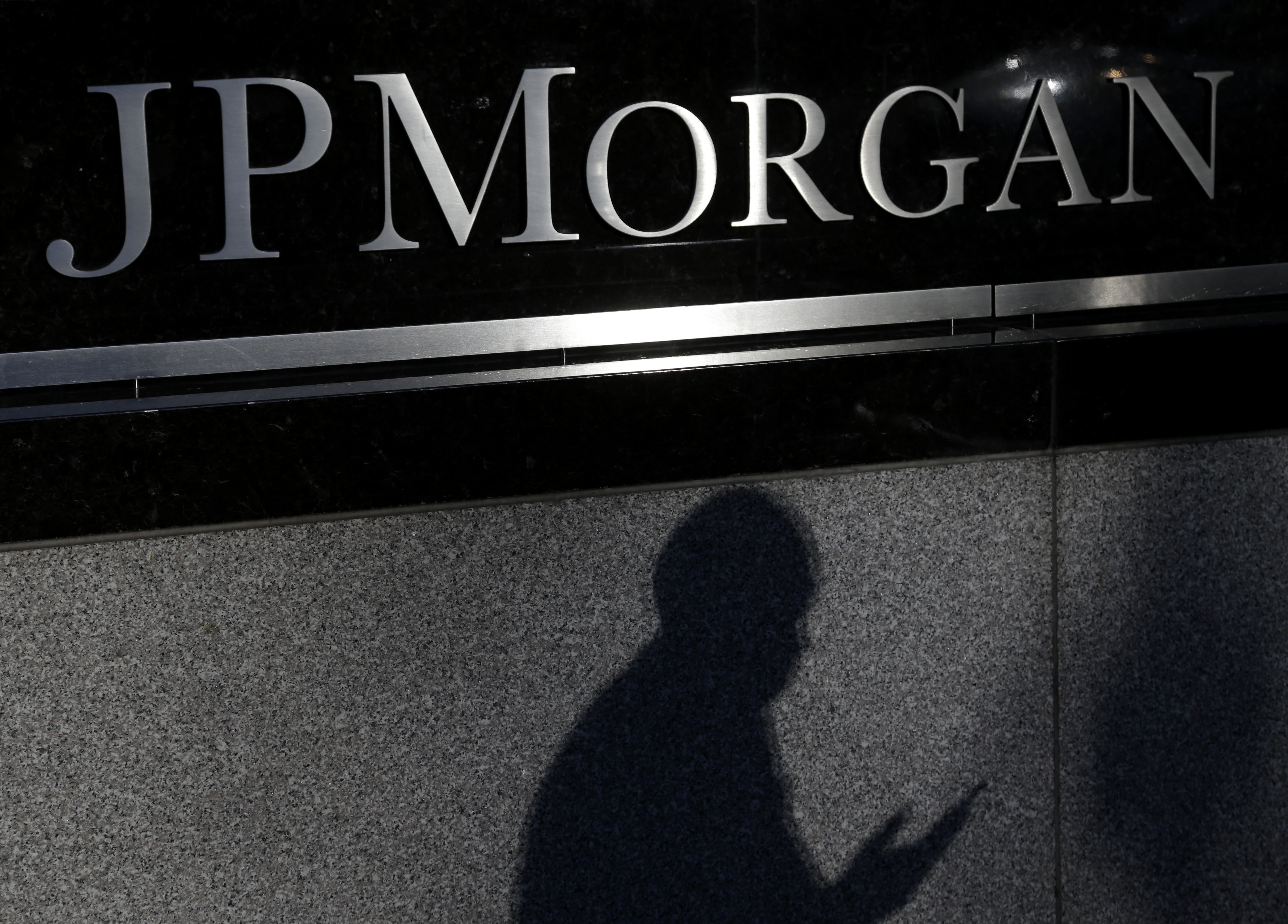 FILE - In this Nov. 19, 2013, file photo, the shadow of a pedestrian is cast under a sign in front of JPMorgan Chase & Co. headquarters in New York. After having just been awarded a multibillion-dollar settlement stemming from the financial crisis, the investment giant launched the hashtag (hash)AskJPM for people to ask career advice questions. But the move badly underestimated consumer sentiment toward banks and showed a tone of deafness to how social media works. (AP Photo/Seth Wenig, File) (AP)