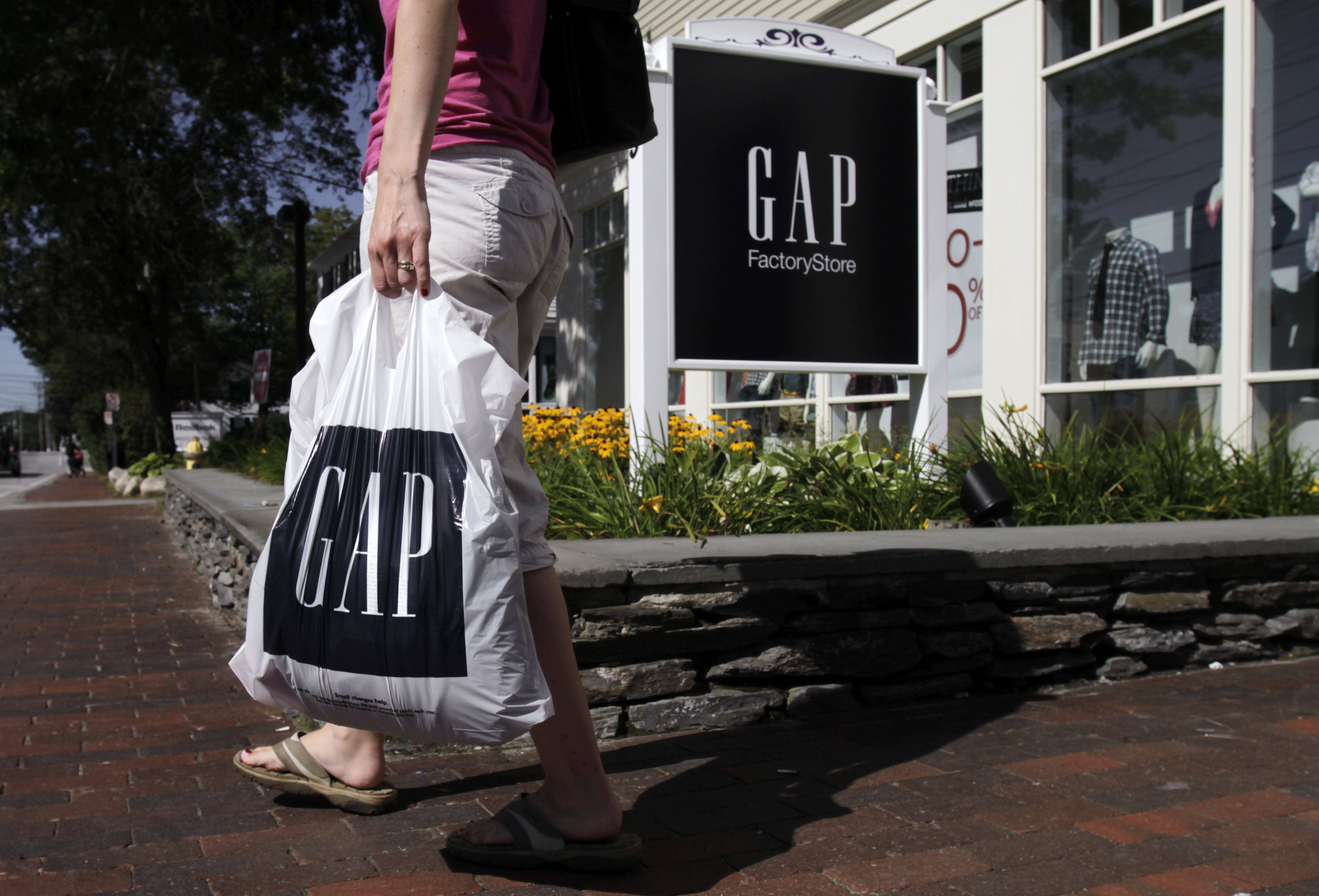 FILE - In this Wednesday, Aug. 17, 2011, file photo, a shopper leaves the Gap store in Freeport, Maine.  (AP Photo/Pat Wellenbach, File) (AP)