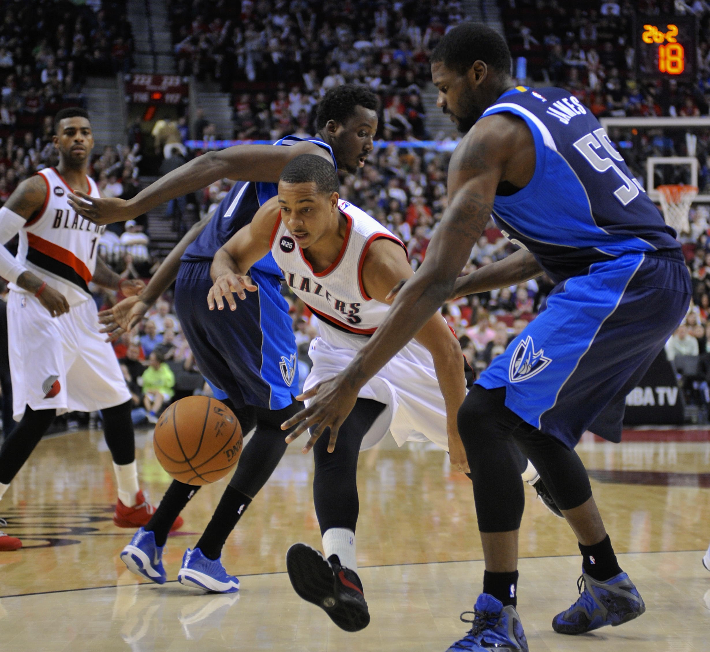 Portland Trail Blazers' CJ McCollum (3) drives against Dallas Mavericks'  Al-Faroug Aminu (7) and Bernard James (55) during the second half of an NBA basketball game in Portland, Ore., Thursday, March 5, 2015. The Trail Blazers beat the Mavericks 94-75. (AP Photo/Greg Wahl-Stephens) (AP)
