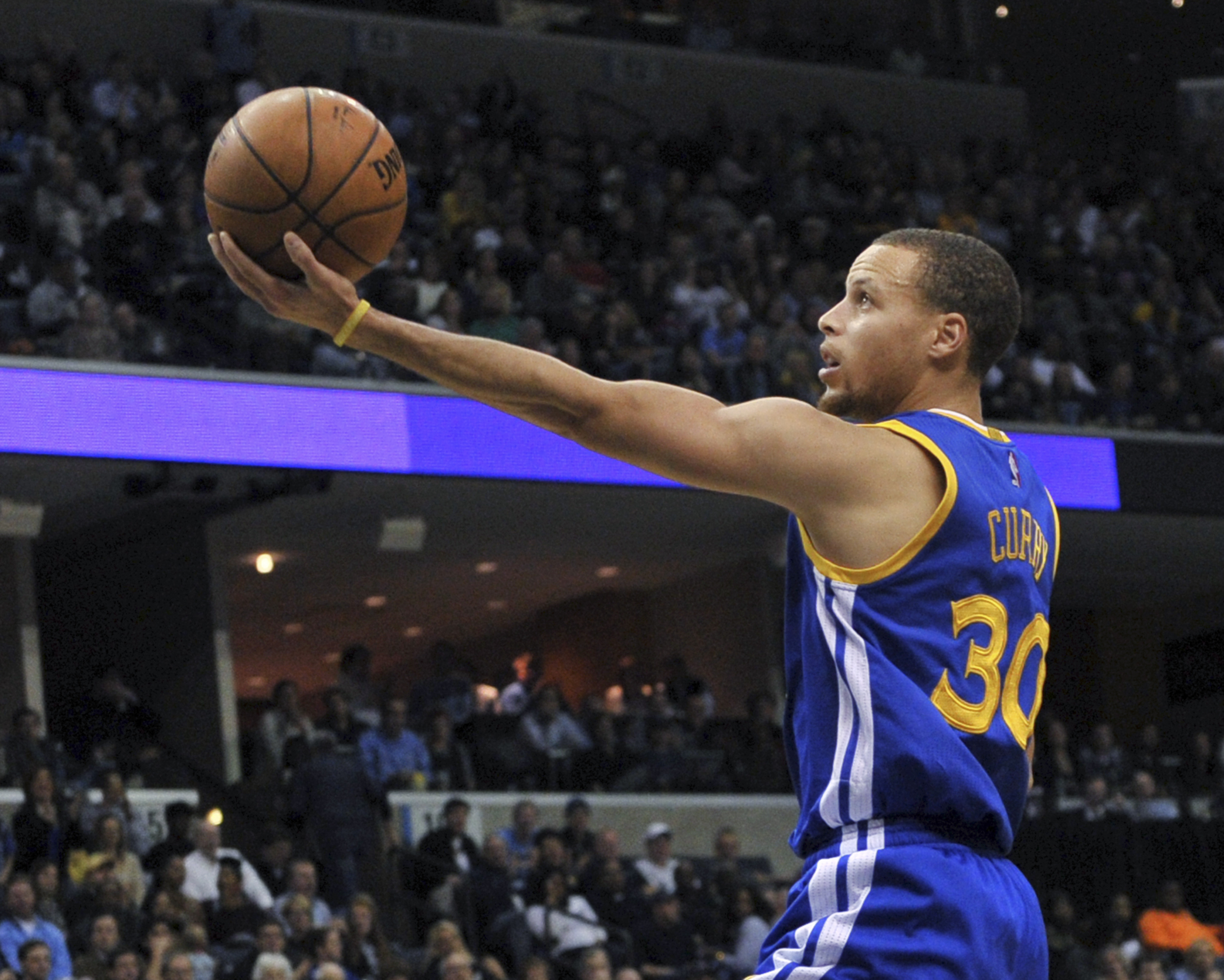 FILE - In this Dec. 16, 2014, file photo, Golden State Warriors guard Stephen Curry goes in for a shot during an NBA basketball game against the Memphis Grizzlies in Memphis, Tenn. Facebook executive Sheryl Sandberg has enlisted NBA stars LeBron James, Curry and some of the basketball league's other top players to convince more men to join the fight for women's rights at home and at work. The players will deliver the message in public service announcements that will appear during NBA games shown on major TV networks over the next few months. (AP Photo/Brandon Dill, File) (AP)