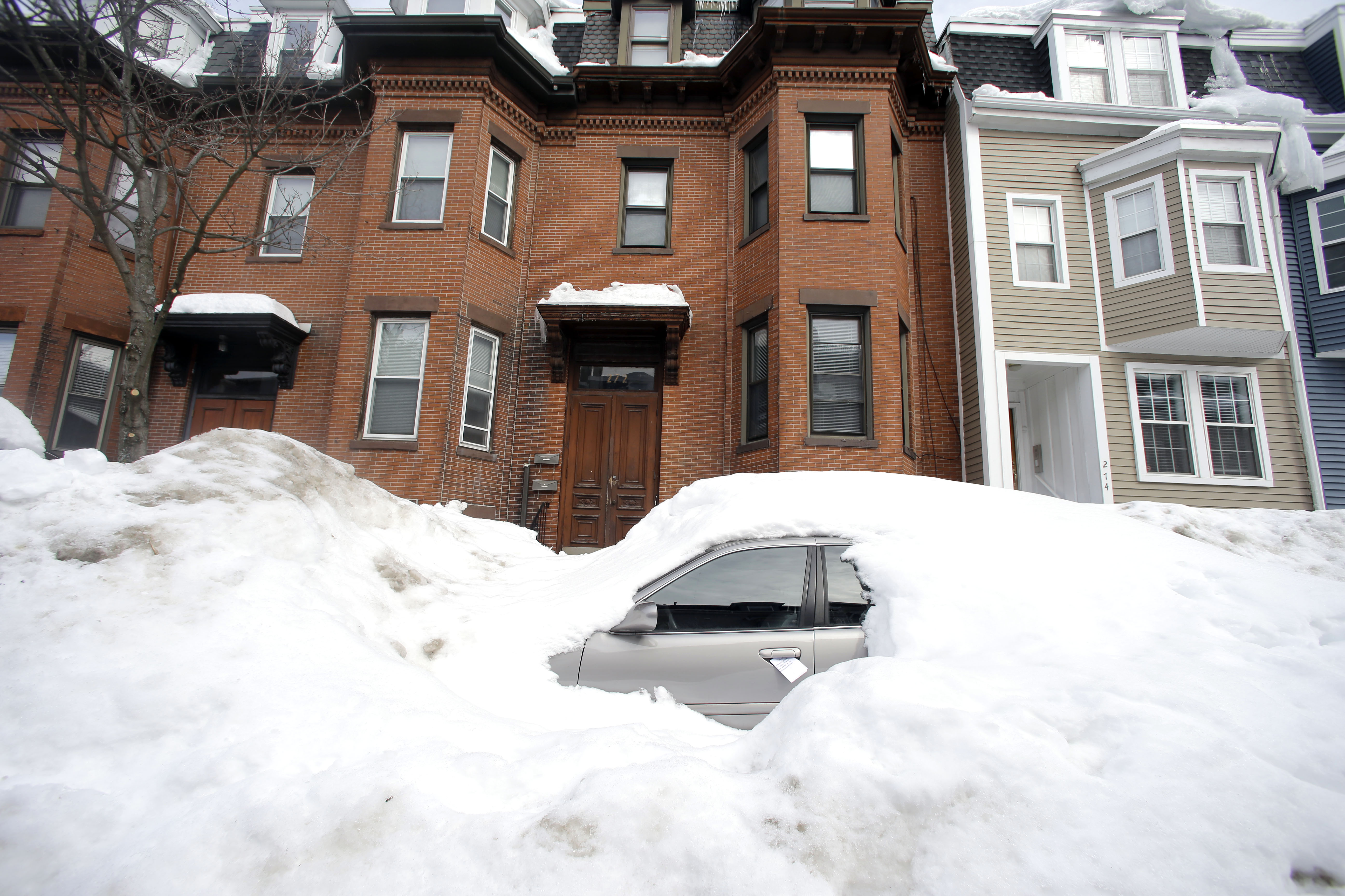 File-In this Feb. 23, 2015 file photo, a car remains buried in snow along a residential street in South Boston. Boston's miserable winter is now also its snowiest season going back to 1872. The official measurement of 108.6 inches at Logan International Airport Sunday night topped a season record of 107.9 inches set in 1995-96. The final 2.9 inches came in a snowstorm that was relatively tame after a record-setting monthly snowfall of 64.9 inches in February. (AP Photo/Elise Amendola, File) (AP)