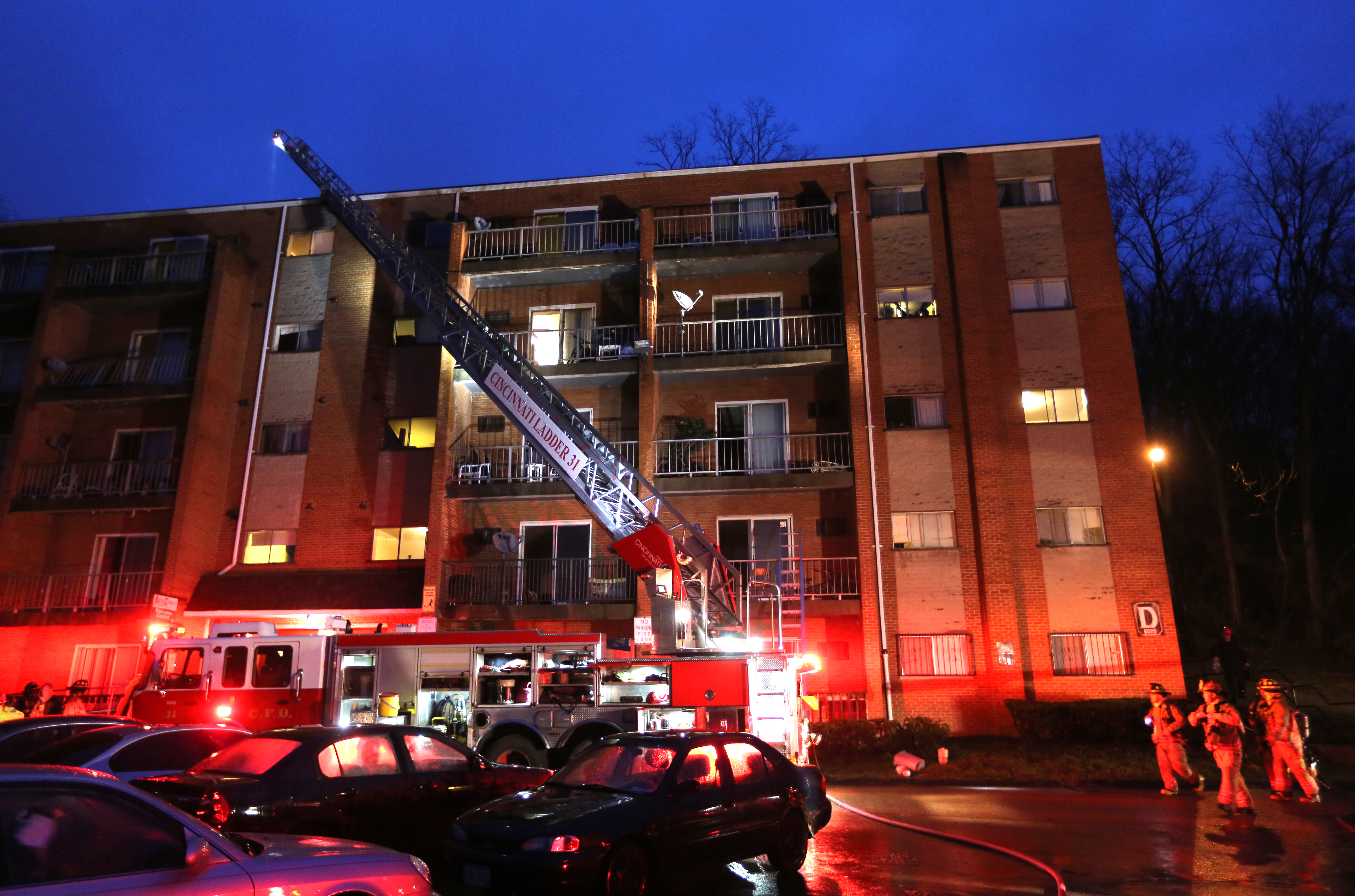 Firefighters work at the scene of a fire at King Towers apartment complex inn Cincinatti that took the life of Cincinatti firefighter Daryl Gordon, Thursday, March 26, 2015. The city says Gordon, 54, died at a hospital Thursday morning after being pulled from a building. Authorities said all residents were safe, but several residents were treated for smoke inhalation.  (AP Photo/The Enquirer, Liz Dufour) (AP)