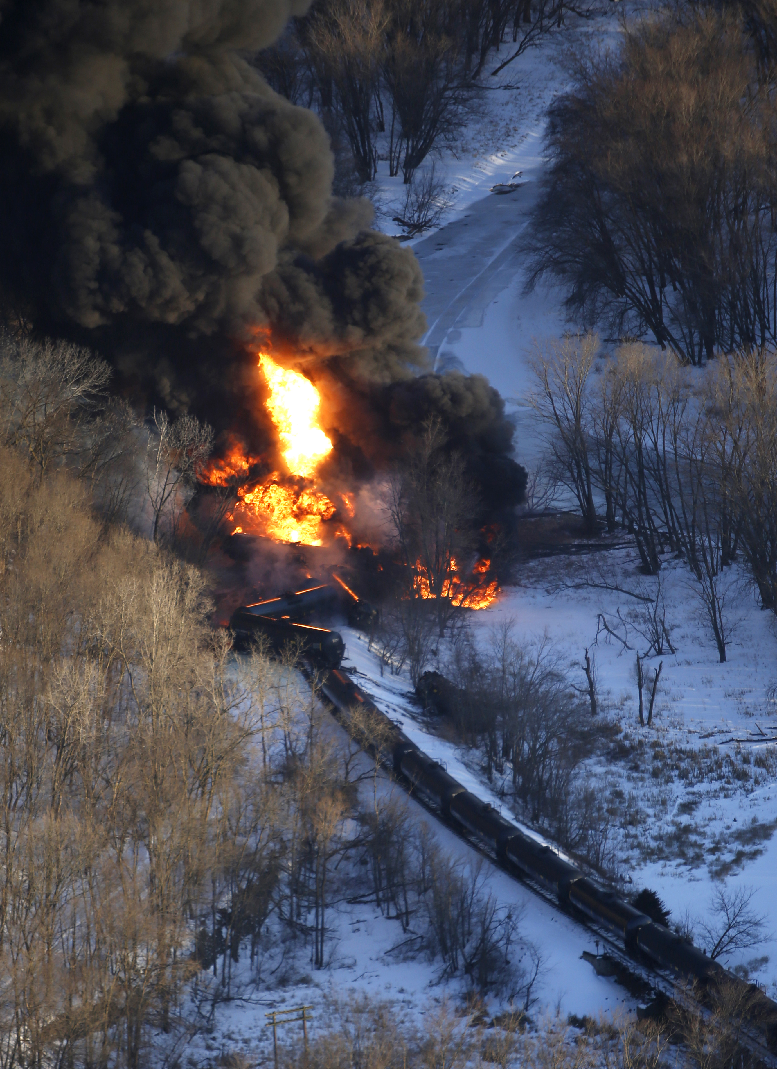 Smoke and flames erupt from the scene of a train derailment Thursday, March 5, 2015, near Galena, Ill. A BNSF Railway freight train loaded with crude oil derailed around 1:20 p.m. in a rural area where the Galena River meets the Mississippi, said Jo Daviess County Sheriff's Sgt. Mike Moser. (AP Photo/Telegraph Herald, Mike Burley) (AP)