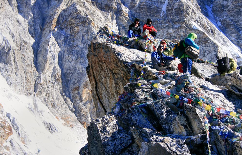Unknown people squatting on the top of the Kala Patthar Mountain near Mount Everest Base Camp in the Himalayas, Nepal. (PlusONE/Shutterstock)