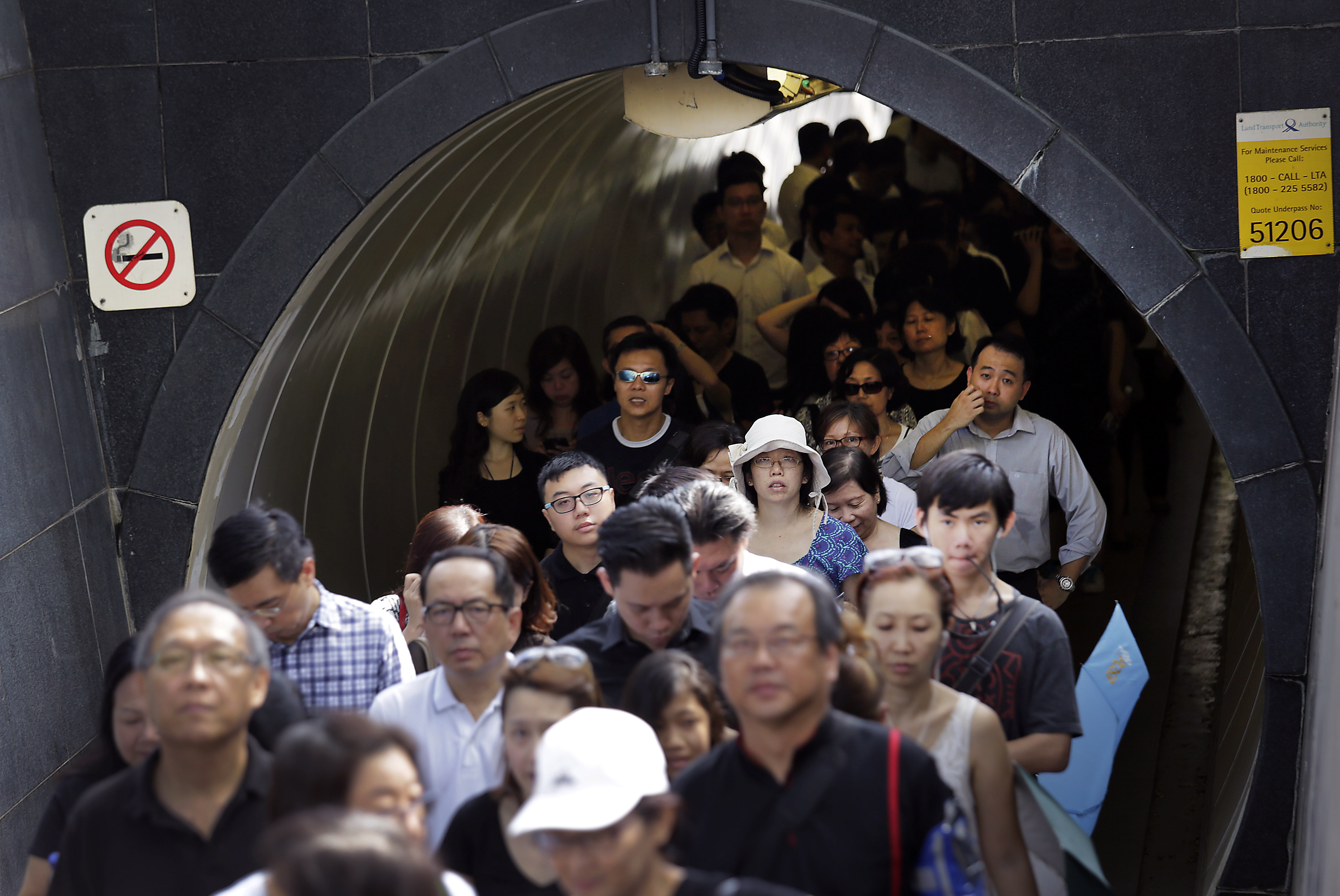 In this Thursday, March 26, 2015, file photo, members of the public wait in line to pay their respects to the late Lee Kuan Yew at the Parliament House where he is lying in state for four days, Thursday, March 26, 2015, in Singapore. Lee, 91, died Monday at Singapore General Hospital after more than a month of battling severe pneumonia. (AP Photo/Wong Maye-E) (AP)