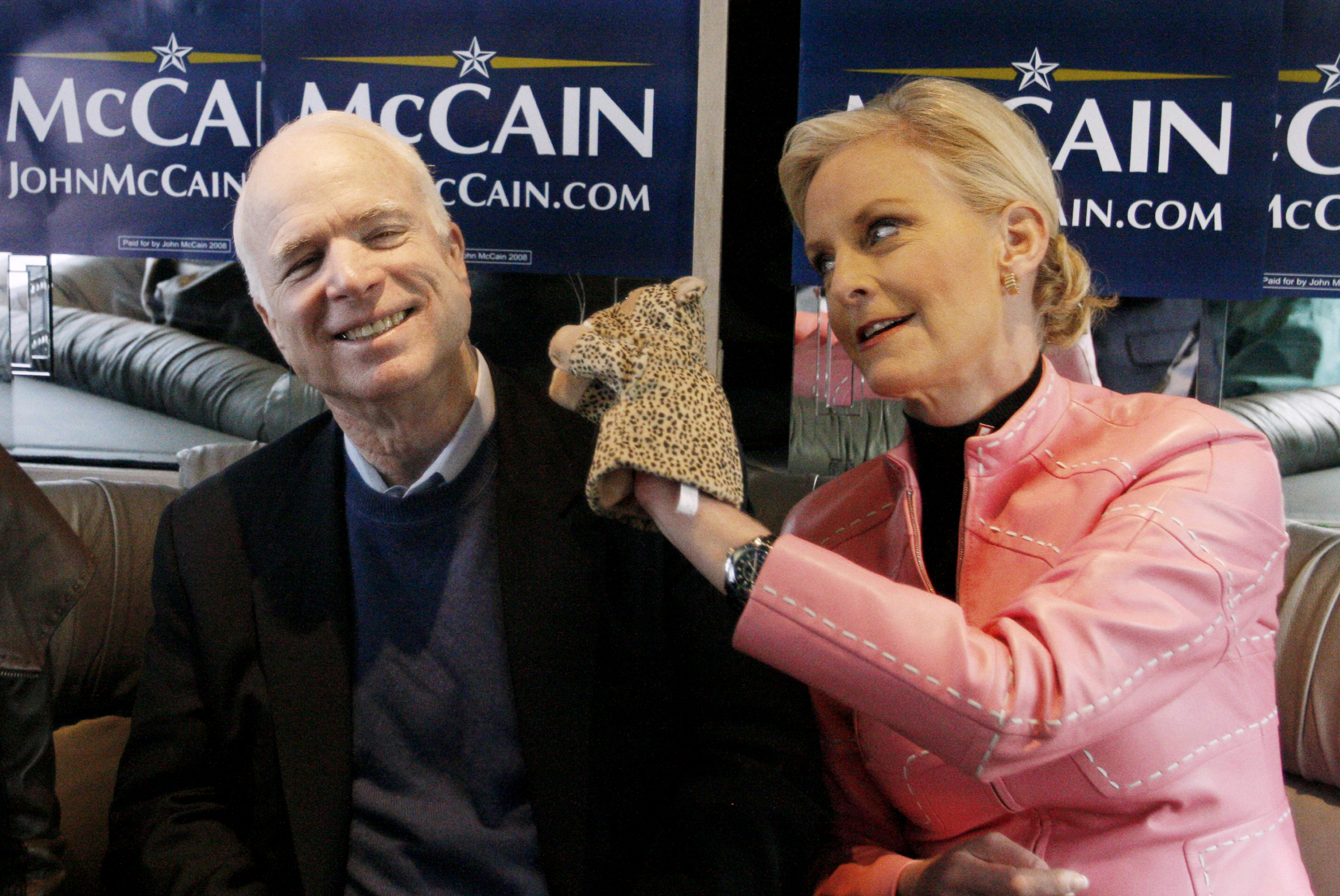 FILE - In this Jan. 19, 2008 file photo, Cindy McCain, wife of Republican presidential hopeful Sen. John McCain, R-Ariz., uses a cheetah hand puppet to make her husband laugh as they ride the "Straight Talk Express" campaign bus to a polling station on the day of South Carolina's Republican presidential primary in Charleston, S.C. "A campaign is like the world's longest job interview, and even though most of us like to think that we're being our natural selves when we interview for a new job, it's only human nature to self-edit ourselves and try to make the best possible impression," says Schnur, director of the University of Southern Californias political institute. (AP Photo/Charles Dharapak, File) (AP)
