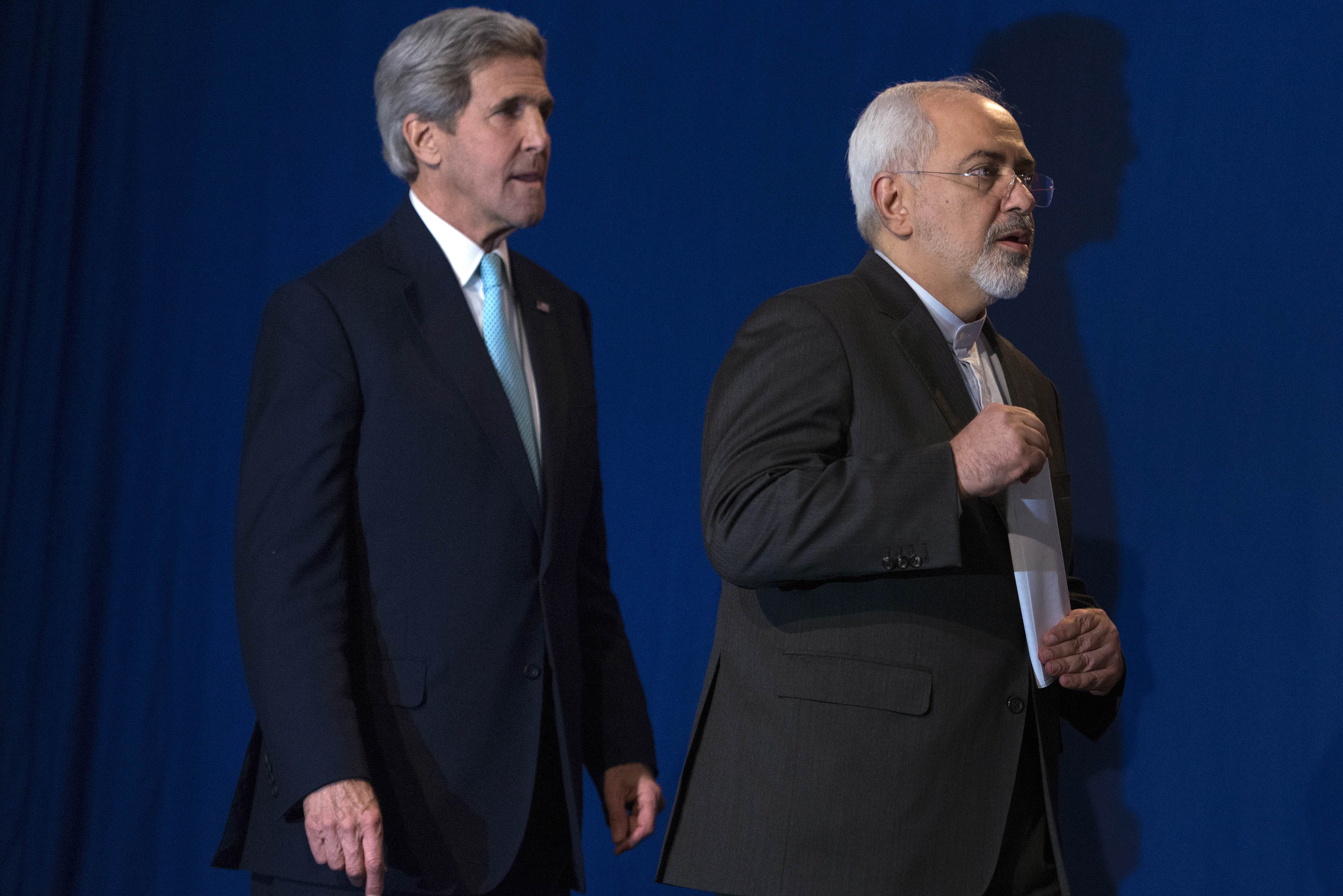 US Secretary of State John Kerry, left, and Iranian Foreign Minister Javad Zarif after Iran nuclear program talks finished with extended sessions. (AP Photo/Brendan Smialowski)