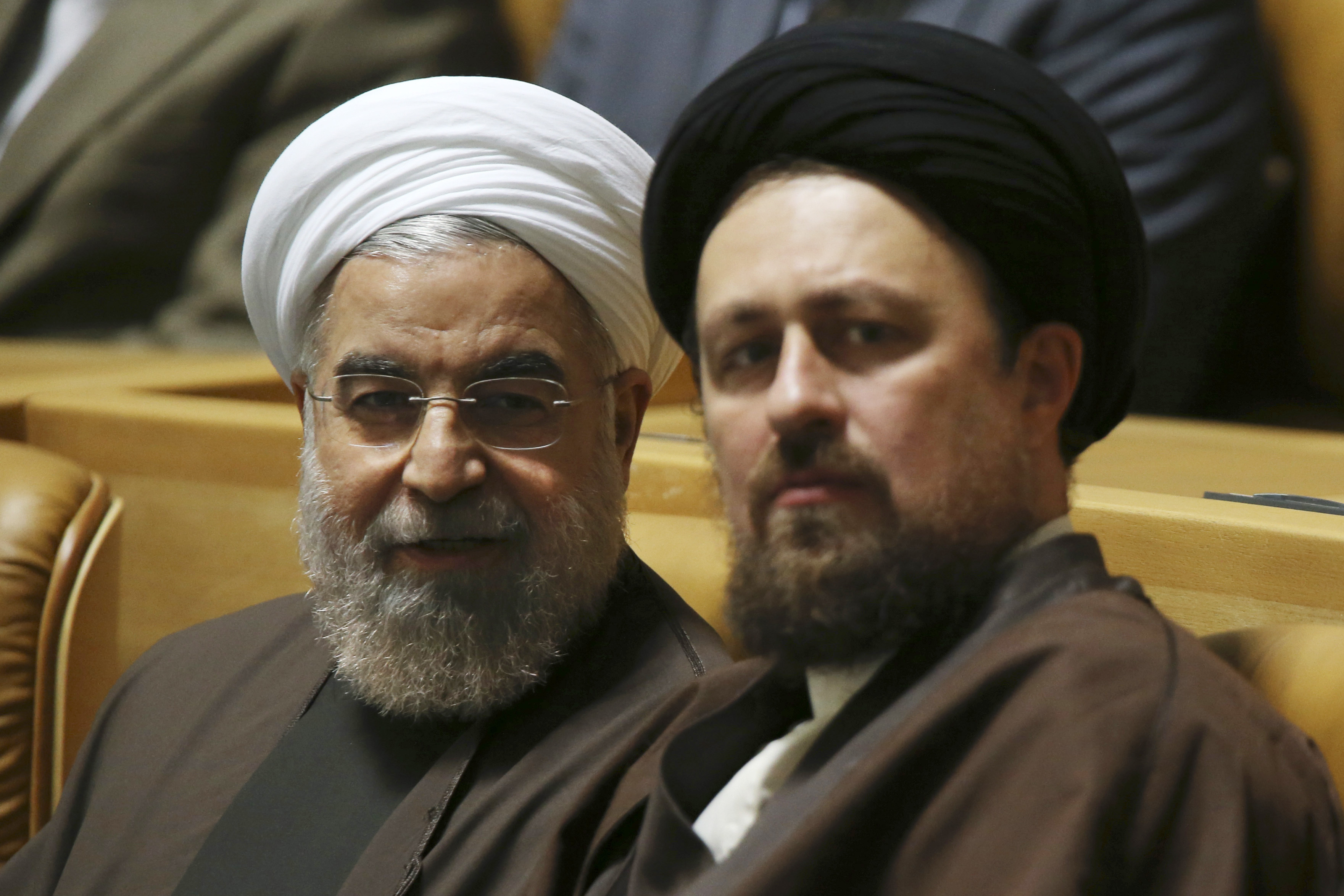 Iranian President Hassan Rouhani, left, talks to Hassan Khomeini, grandson of late revolutionary founder Ayatollah Khomeini. ( (AP/Vahid Salemi)